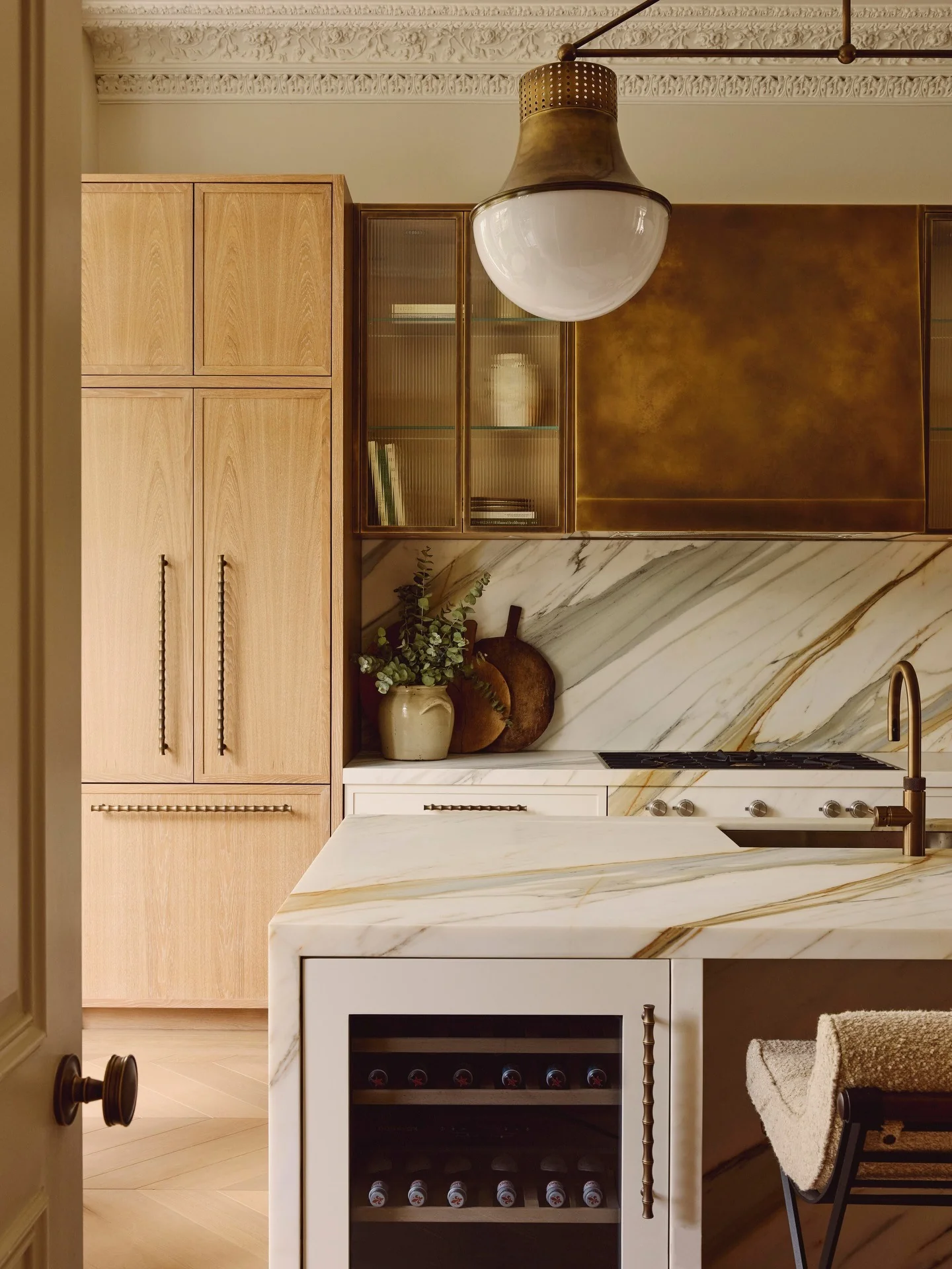 5. Light Oak Tall Cabinets with Stone and Brass Details (Tall Kitchen Cabinets Ideas)