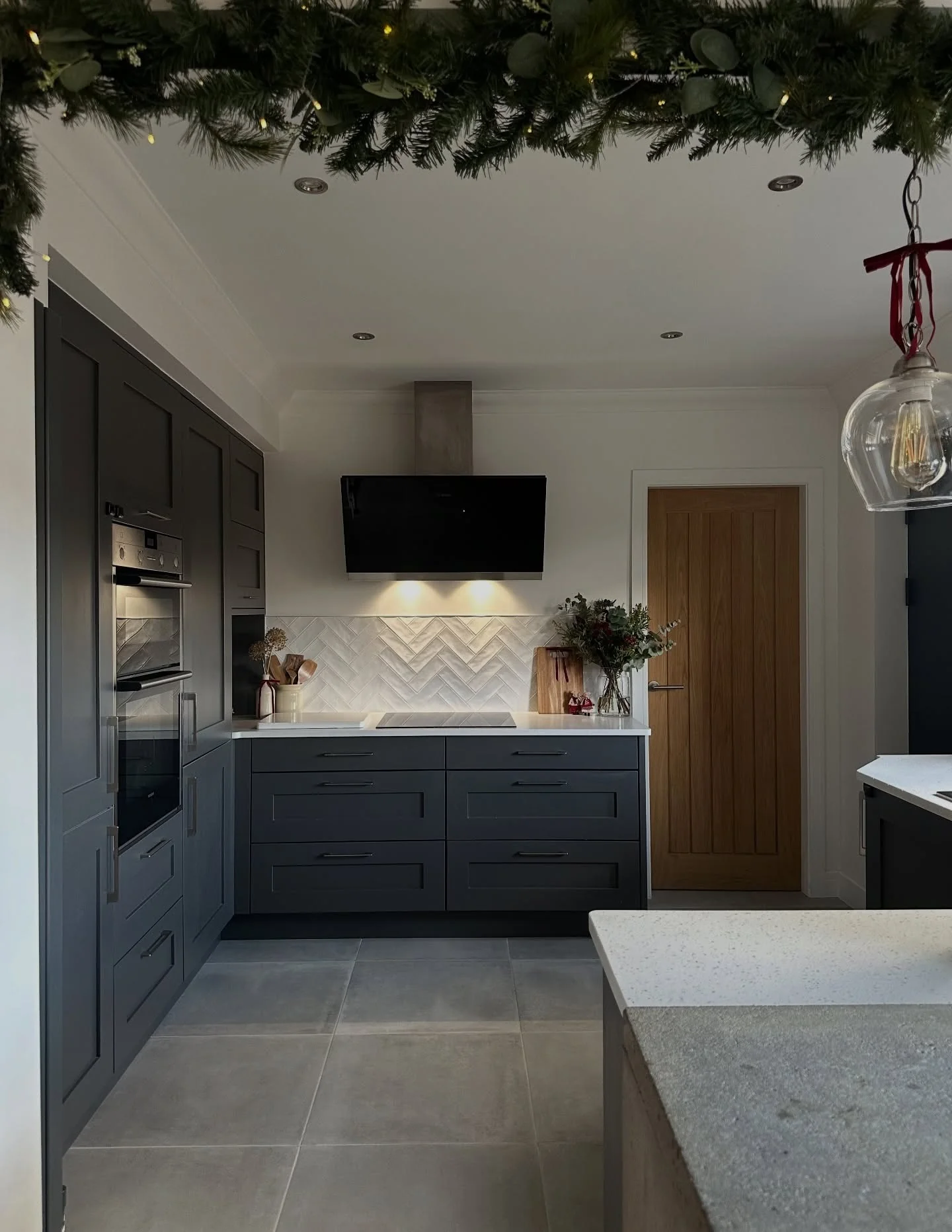 2. Dark Grey Flooring Paired with Charcoal Cabinets (Grey Floor Kitchen Ideas)