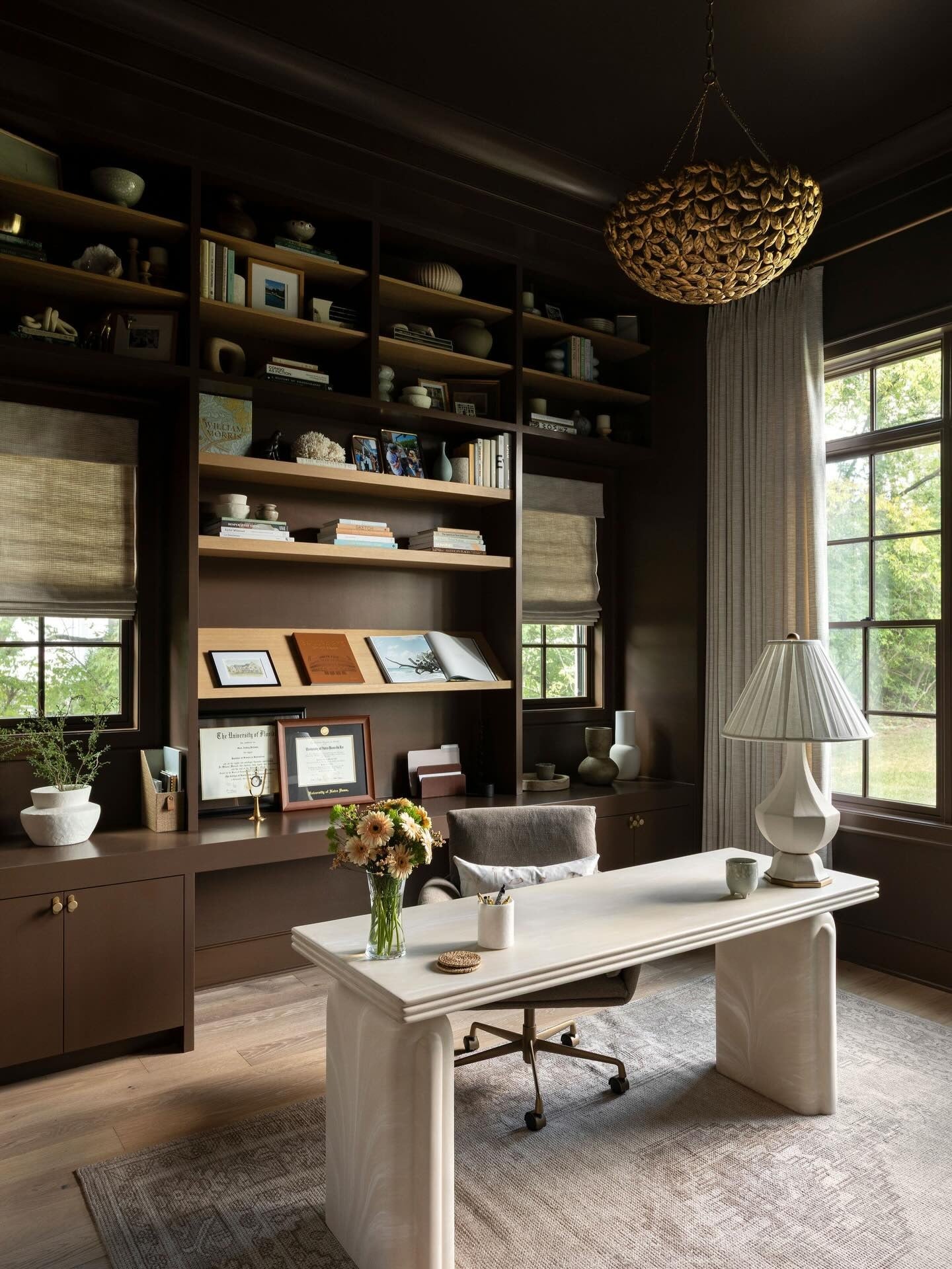 4. Chocolate Brown Office with Custom Shelving and Cream Desk (Moody Office Ideas)