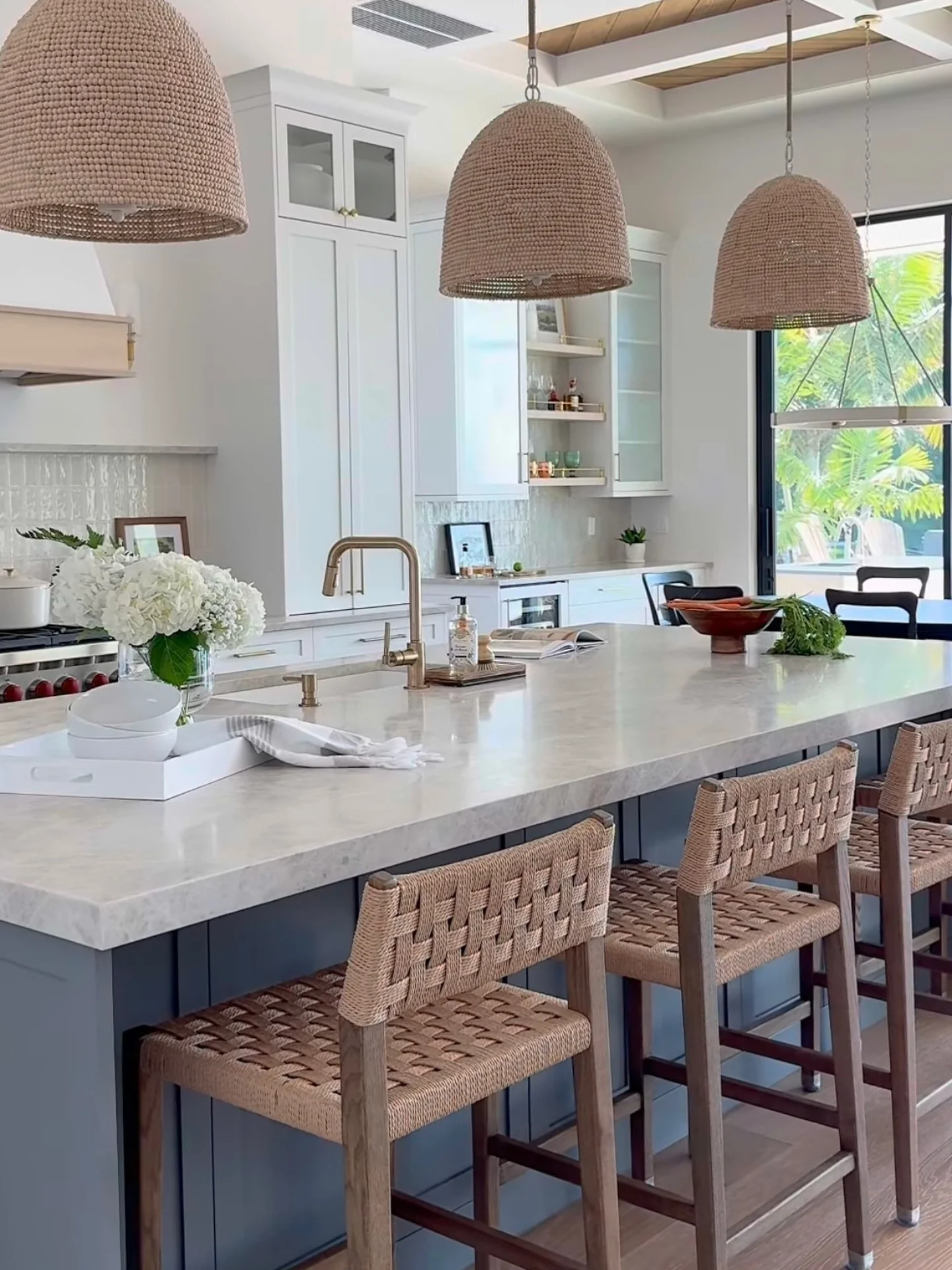 14. Navy Island with Natural Fiber Pendant Lighting (Coastal Kitchen Ideas)