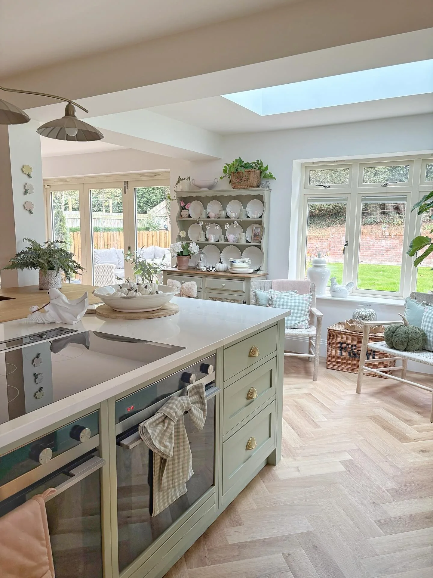 4. Pale Green Island in a Light-Filled Family Kitchen (Green and Wood Kitchen Ideas)