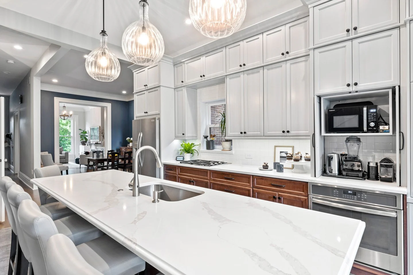 9. Contemporary White Kitchen with Extended Island (Long Narrow Kitchen Ideas)