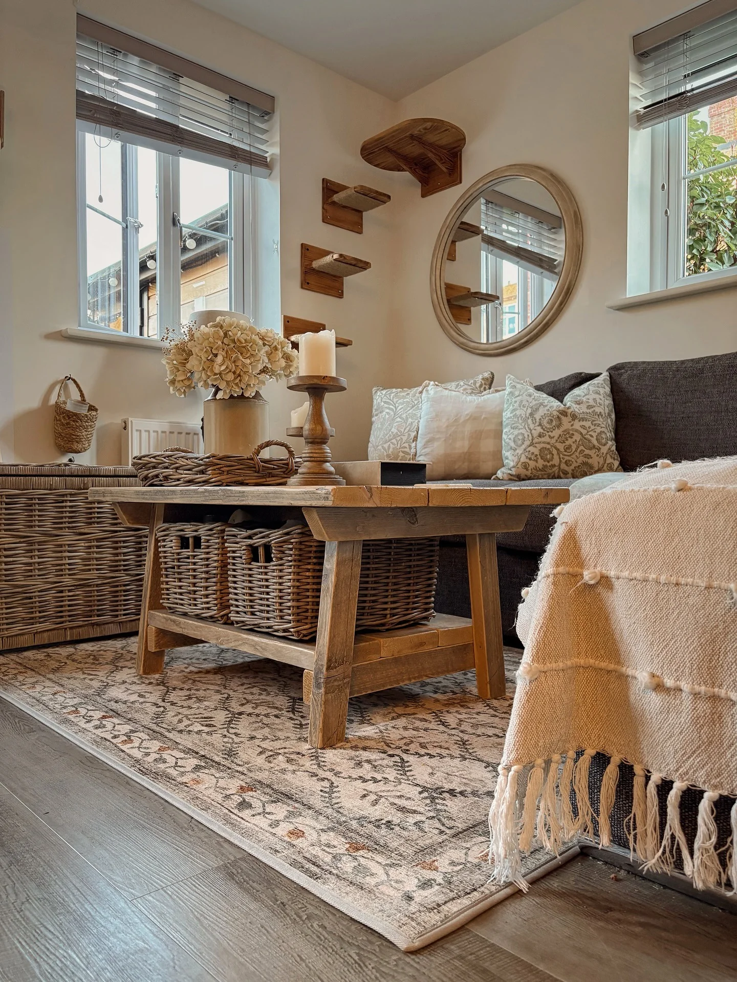 3. Cozy Neutral Rug with Rustic Wood Elements (Living Room Rug Ideas)