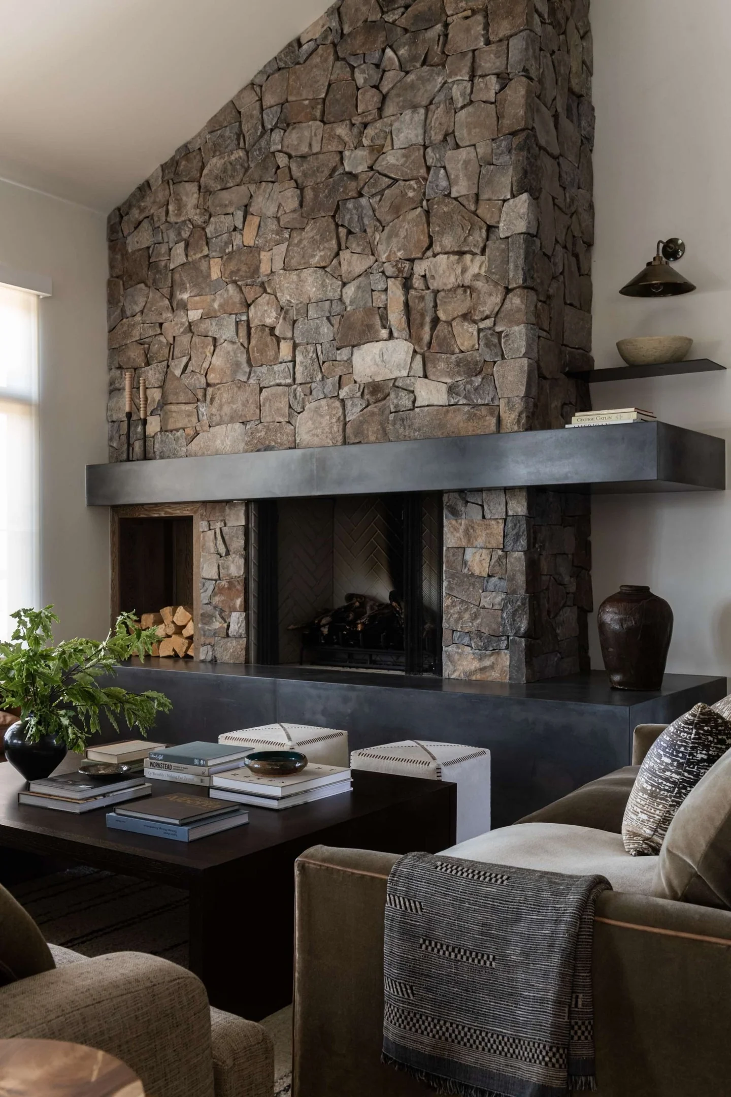2. Modern Mountain Hearth with Charcoal Accents (Stone Fireplace Living Room Ideas)