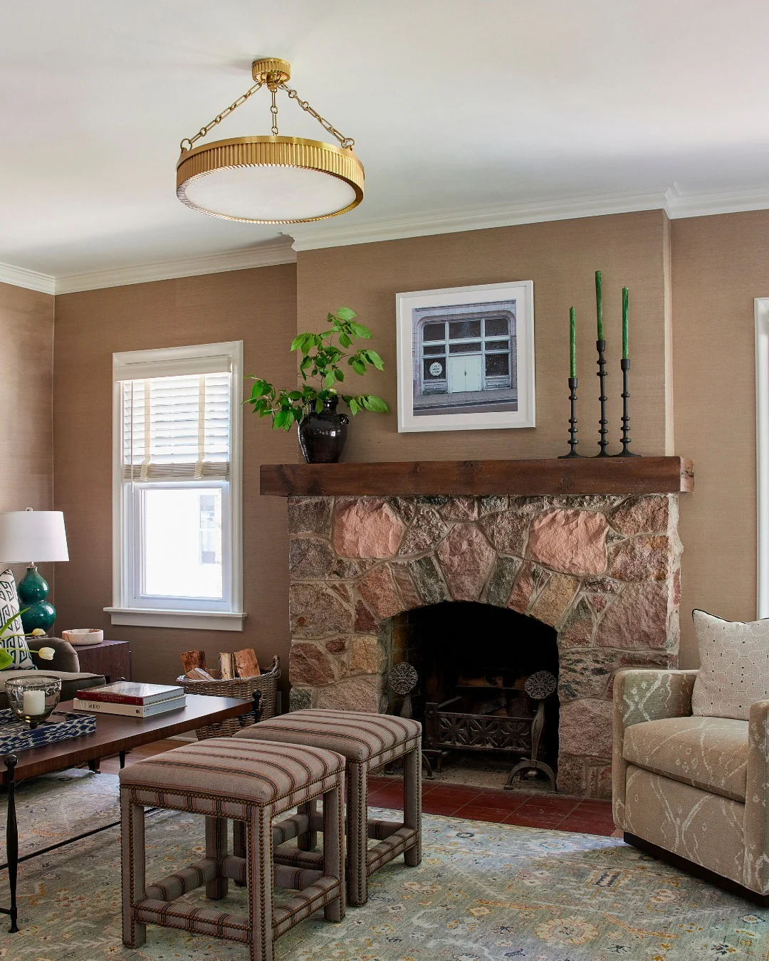 4. Classic Cottage Fireplace with Warm Browns and Greens (Stone Fireplace Living Room Ideas)