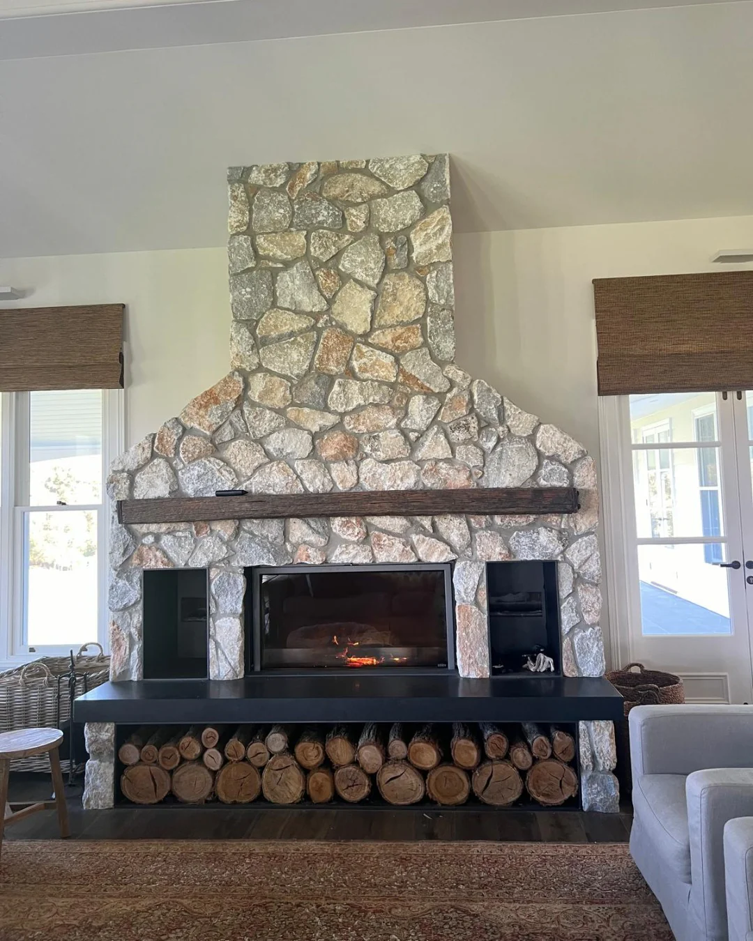 7. Farmhouse Hearth with Natural Stone and Matte Black Accents (Stone Fireplace Living Room Ideas)