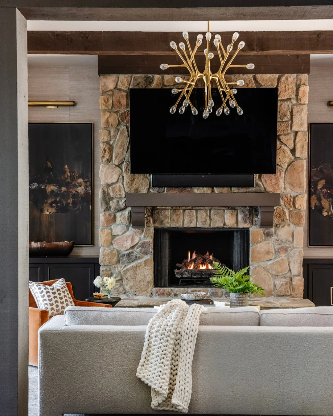 8. Contemporary Lodge with Warm Neutrals and Bronze Details (Stone Fireplace Living Room Ideas)