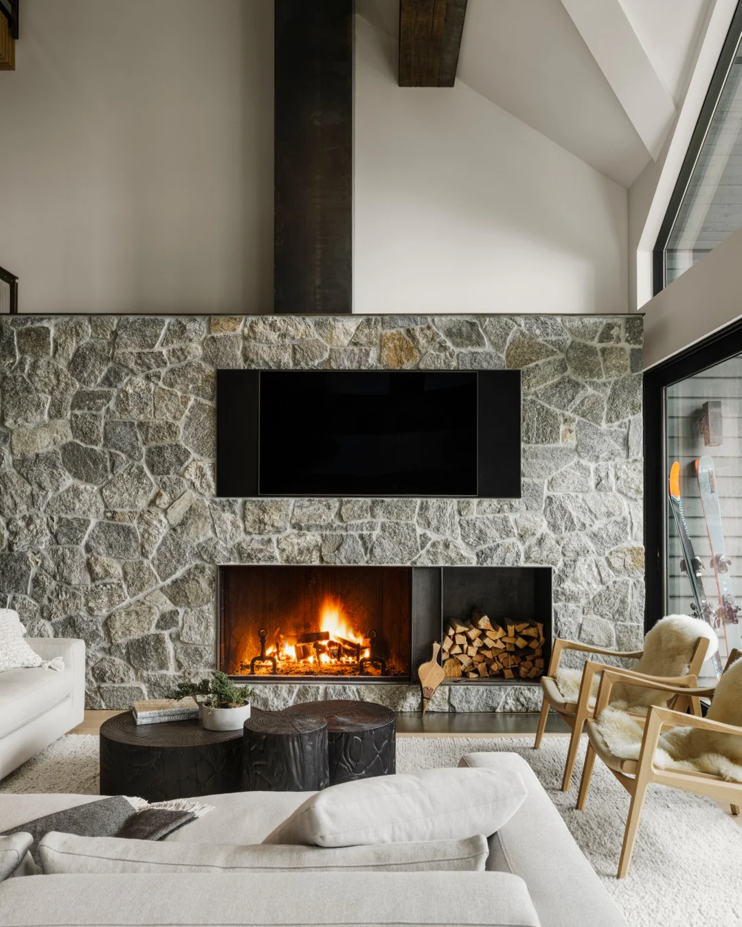 3. Stone-Clad Fireplace Cabin with Cream Upholstery & Charcoal Details (Cabin Living Room Ideas)