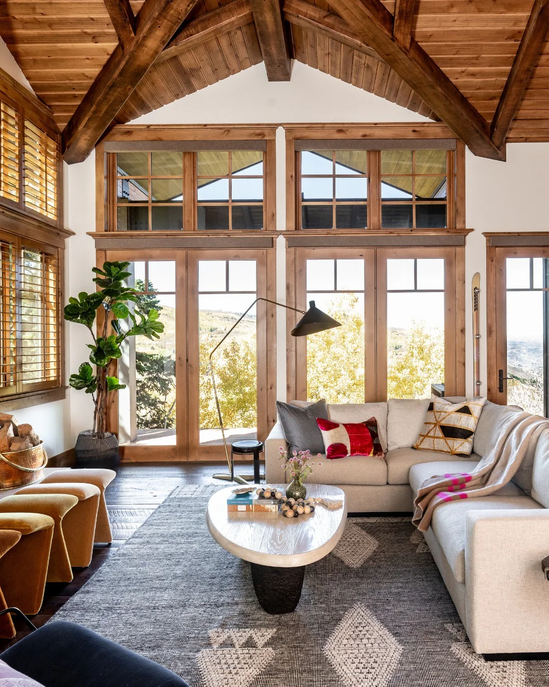 6. Vaulted Ceiling Cabin Living Room with Wood Framing & Soft Neutrals (Cabin Living Room Ideas)