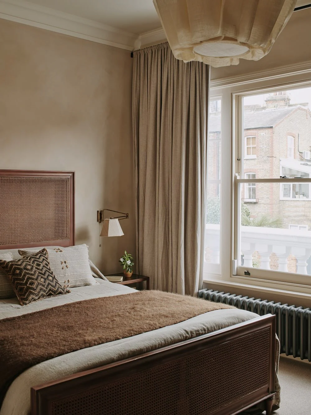 10. Textured Oak Cane Bed with Warm Neutrals (Oak Bedroom Ideas)