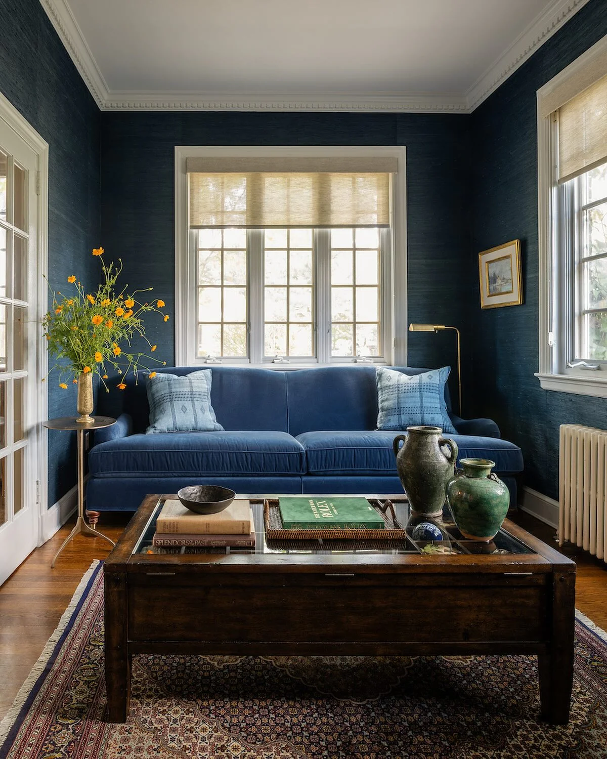 4. Classic Navy Walls with Vintage-Inspired Decor (Navy Blue Living Room Ideas)