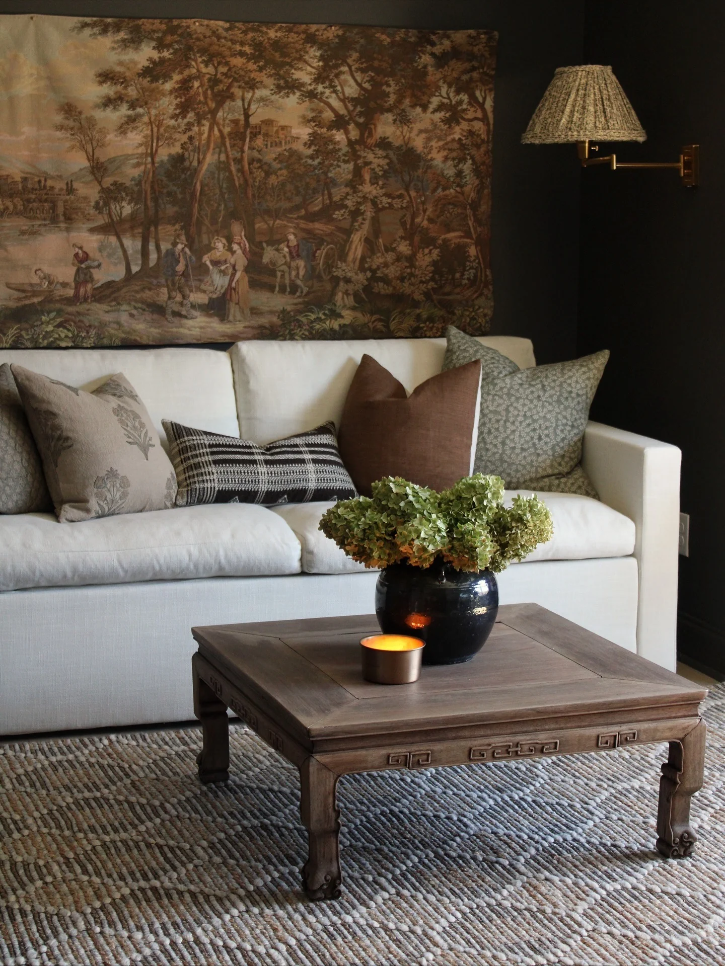 7. Soft Neutral Sofa with Vintage Brown Tapestry (Brown and Black Living Room Ideas)