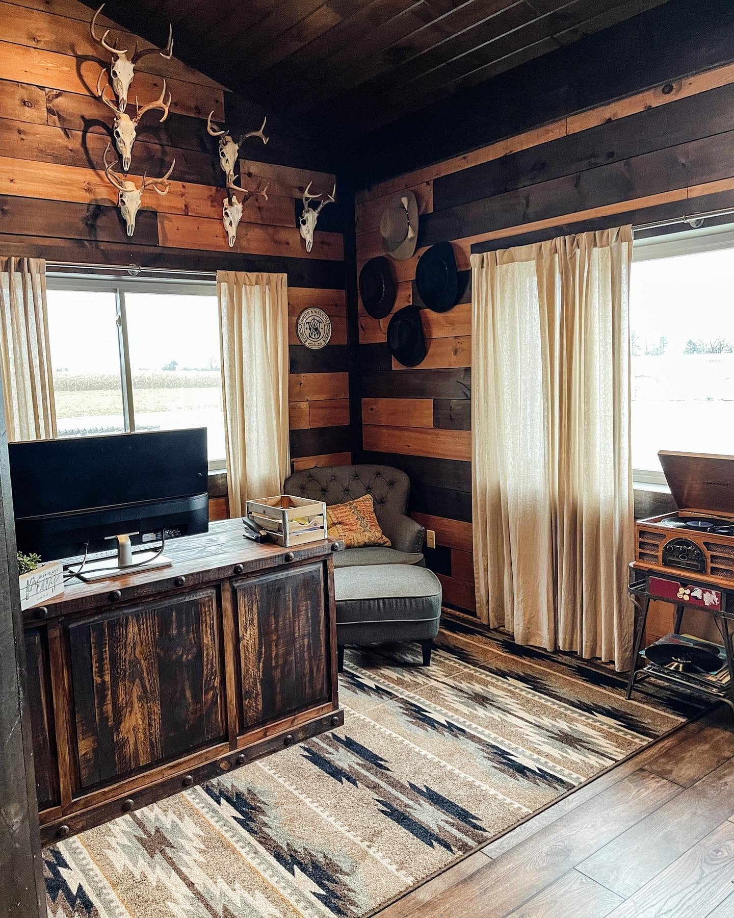 3. Cozy Corner Workspace with Wood Paneling and Trophy Wall (Rustic Office Ideas)