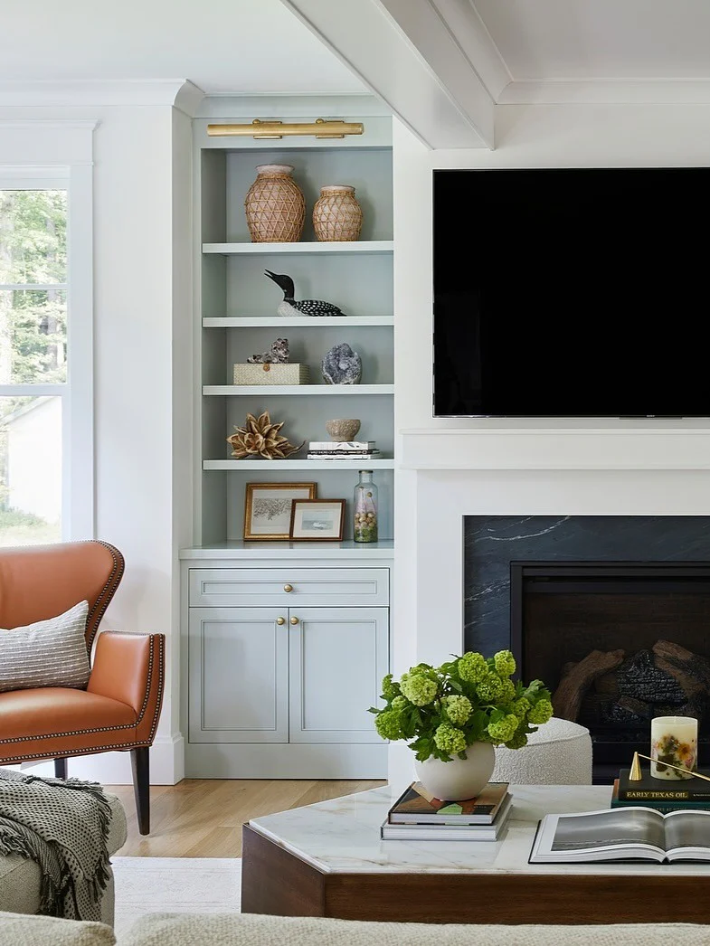3. Built-In Display With Soft Pastels and Brass Accents (Living Room Tv Ideas)