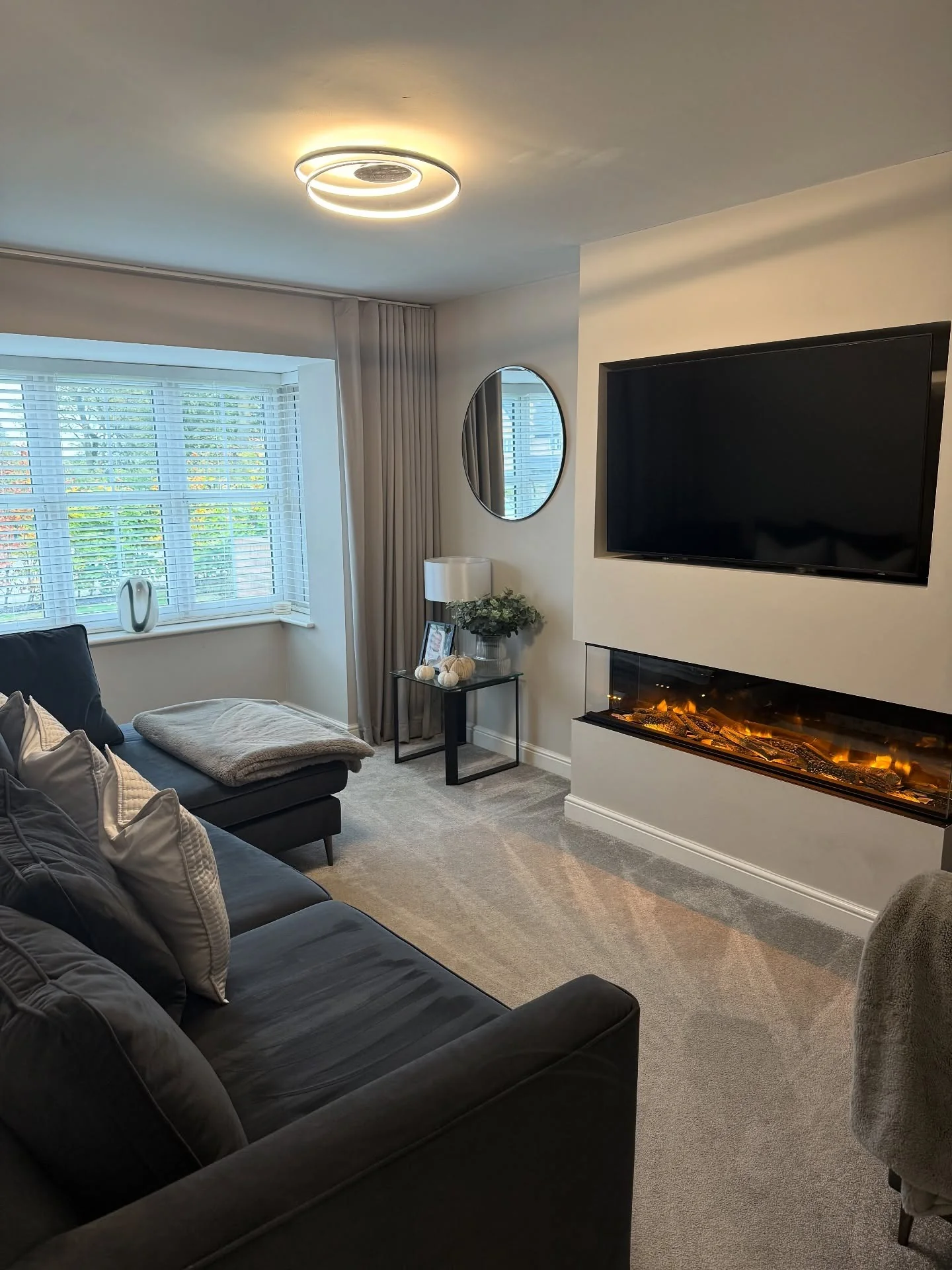 11. Soft Grey Media Wall With Warm Fireplace Glow (Living Room Tv Ideas)