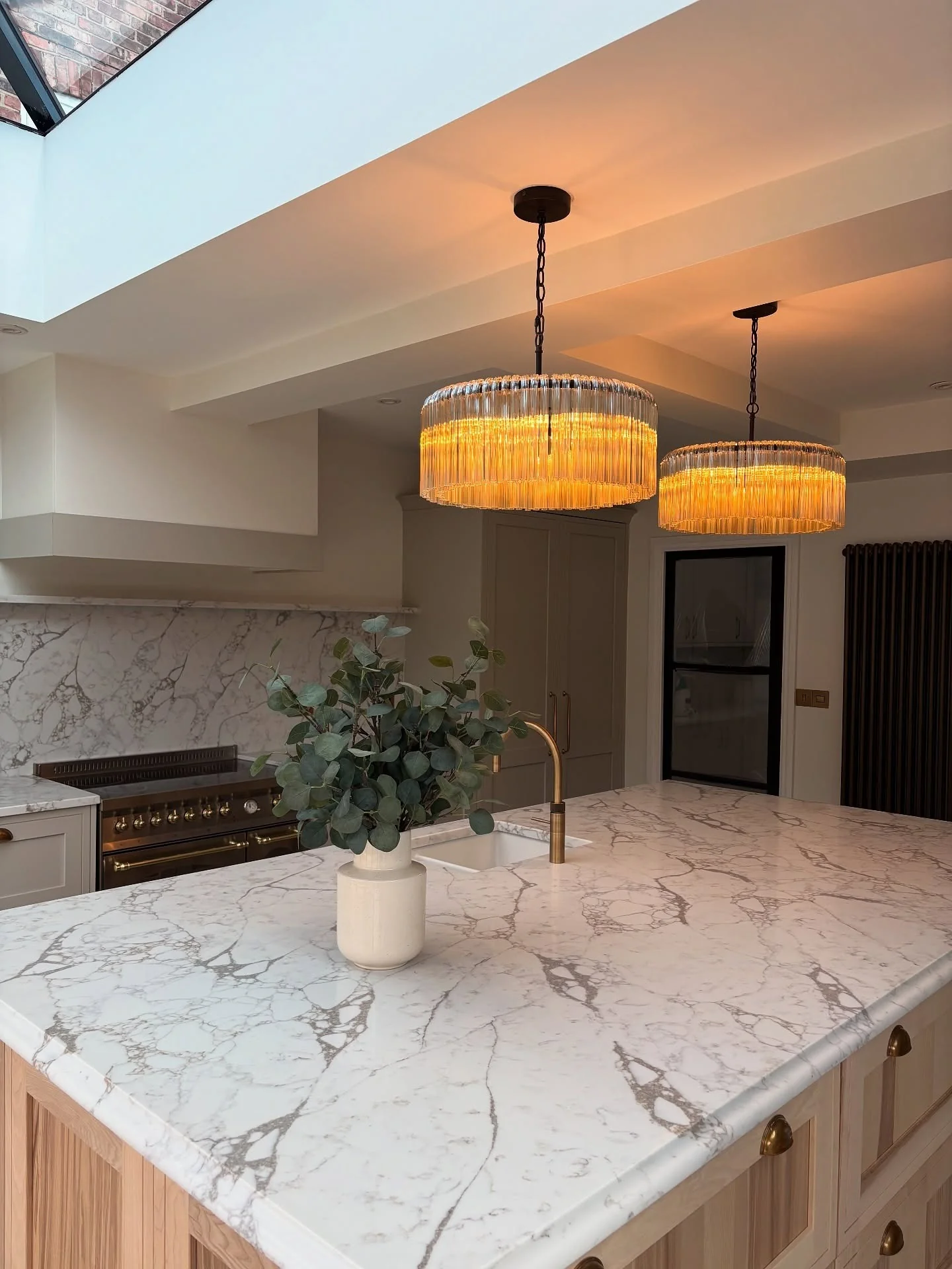 7. Marble Statement with Warm Amber Glow (Kitchen Lighting Ideas)