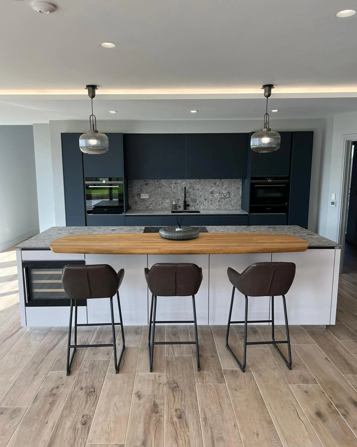 7. Minimalist Sophistication with Natural Textures (Dark Blue Kitchen Ideas)