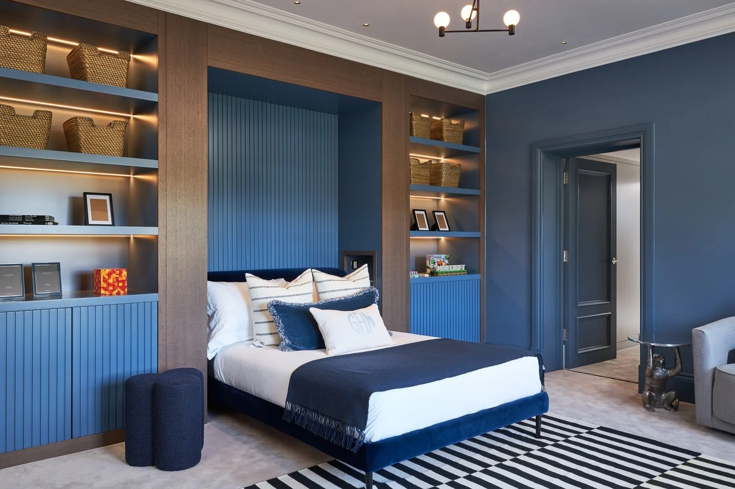 5. Built-In Shelving with Blue Statement Wall (Blue Wall Bedroom Ideas)
