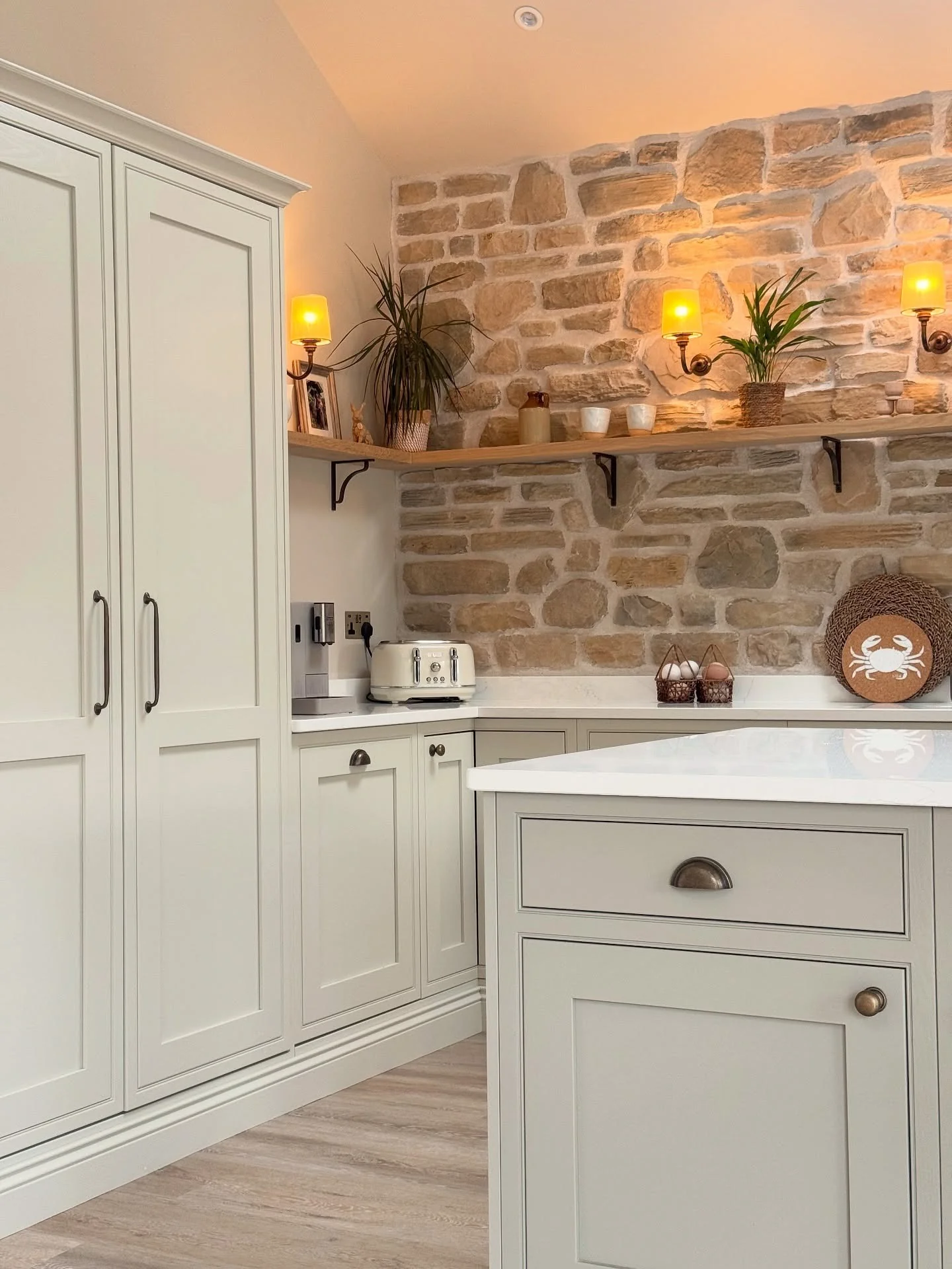 5. Rustic Charm with a Stone Backdrop (Small White Kitchen Ideas)