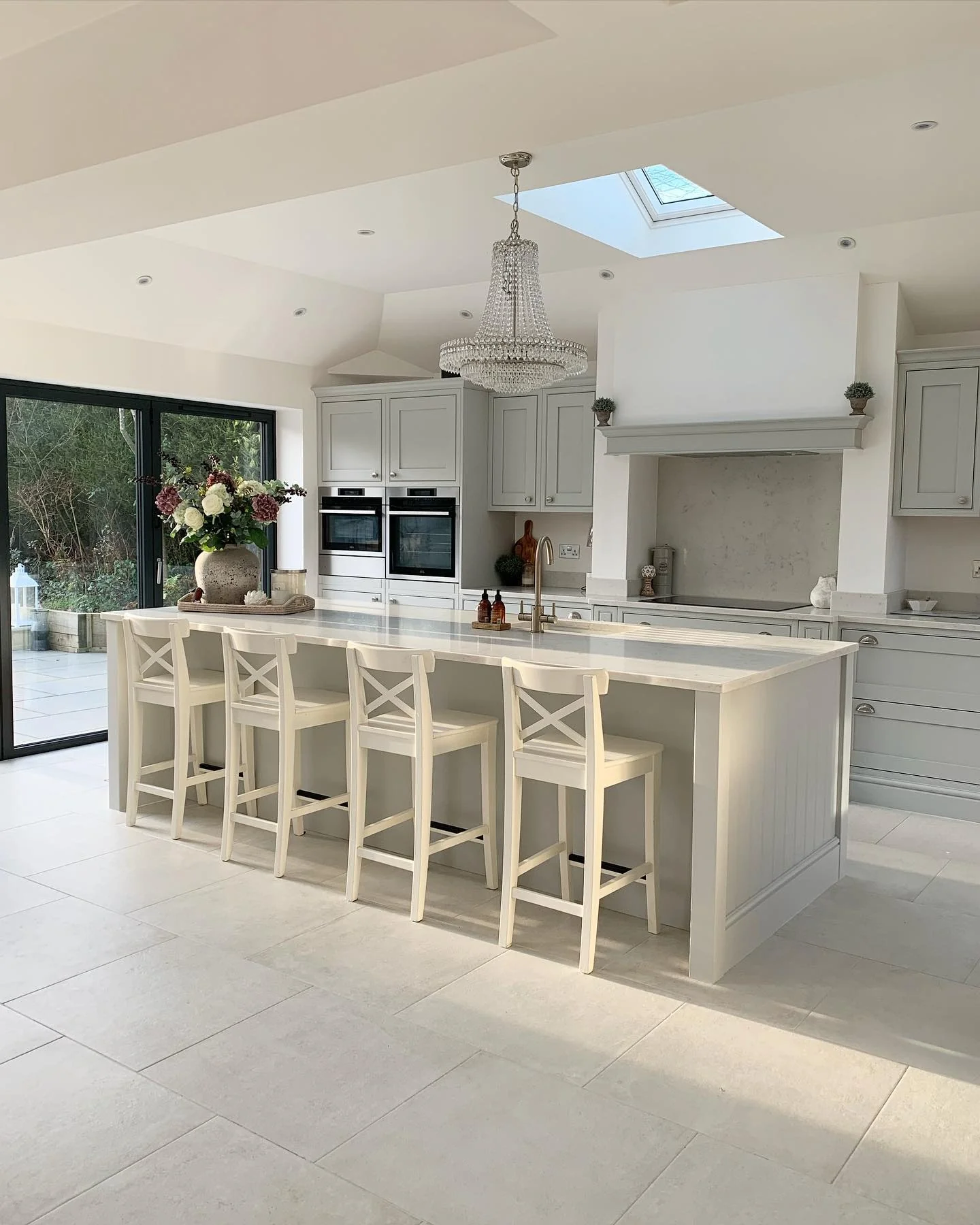 6. Bright and Airy with a Chandelier Touch (White Kitchen Floor Ideas)