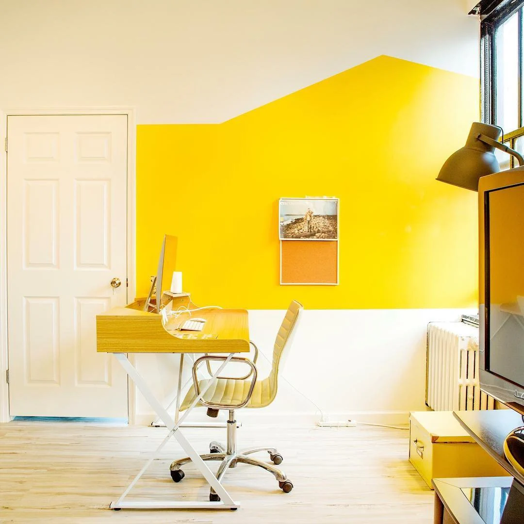 7. Minimalist Office with Geometric Yellow Wall (Yellow Office Ideas)