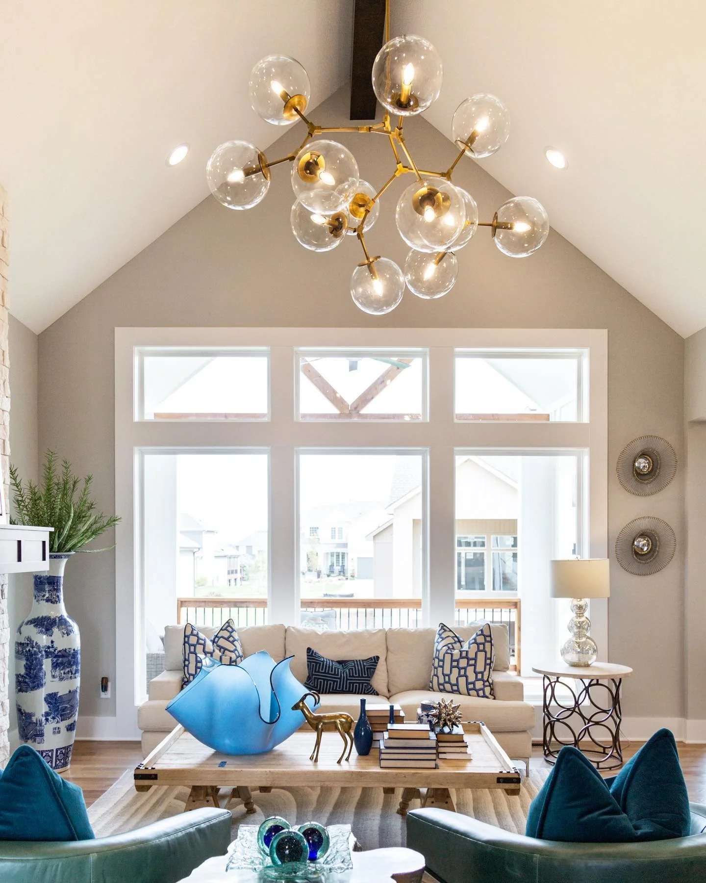 4. Contemporary Balance in Neutrals and Blue (Living Room Chandelier Ideas)
