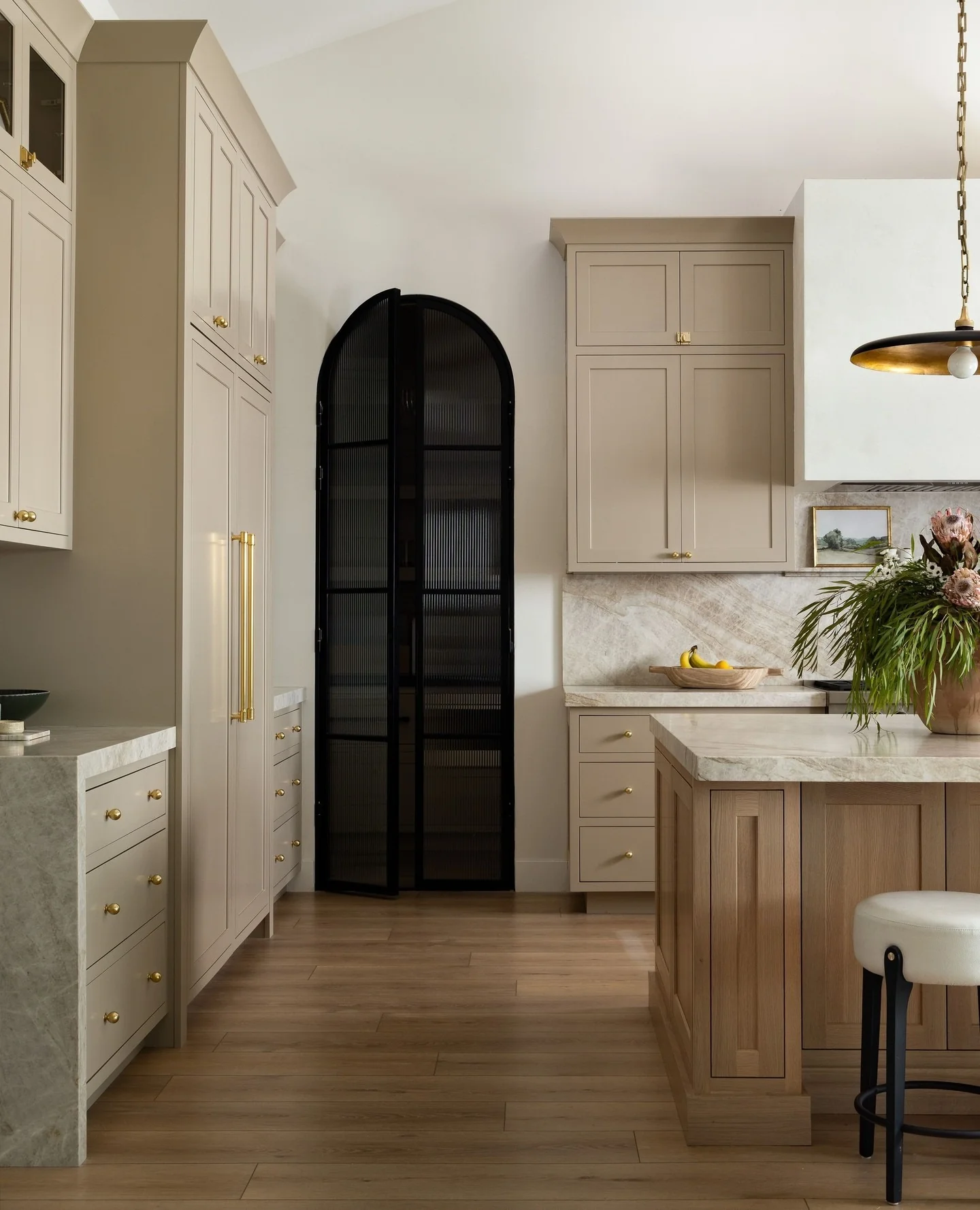 2. Warm Taupe with Black Iron Details (Kitchen Cabinet Paint Ideas)