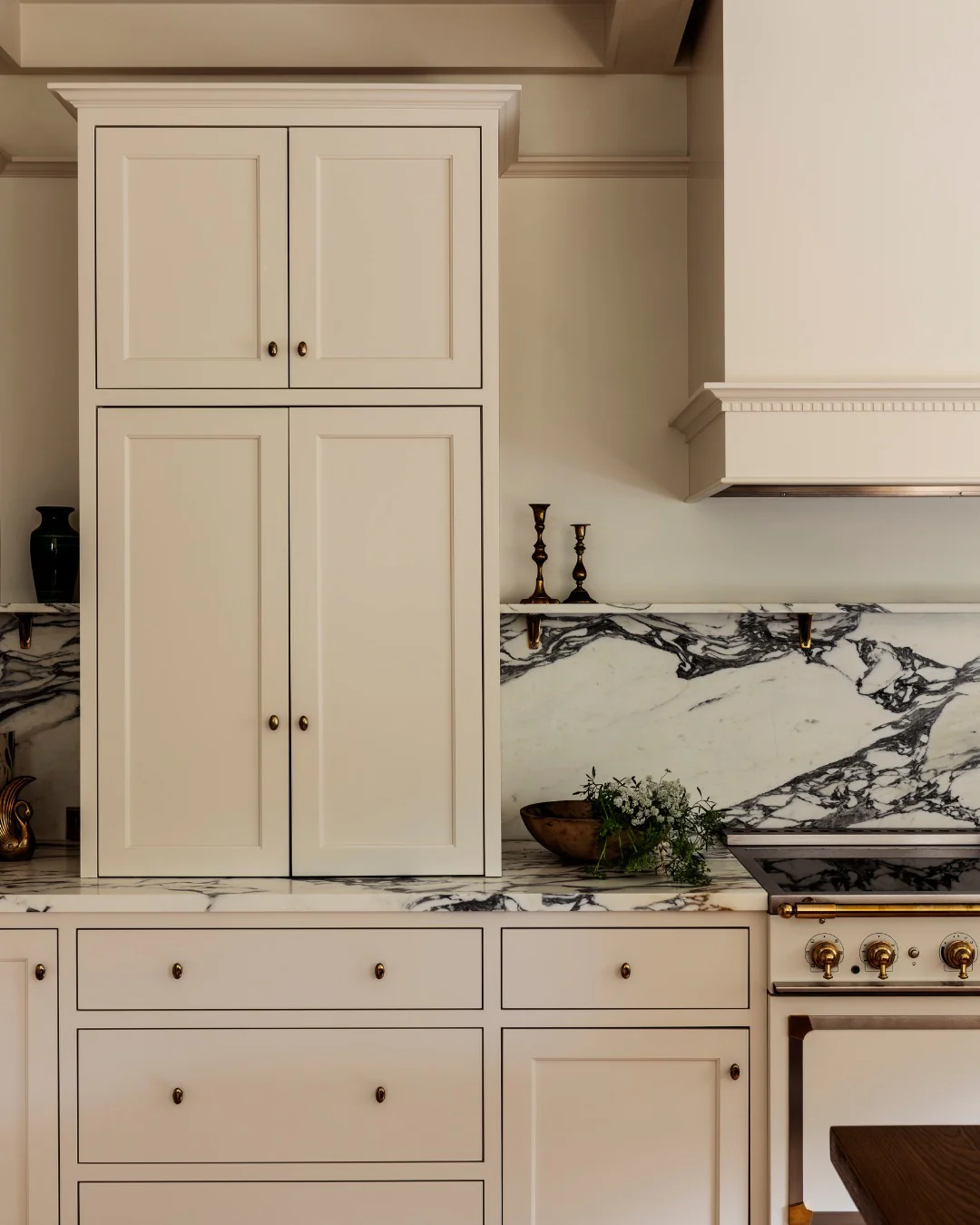 13. Creamy White with Bold Marble Detailing (Kitchen Cabinet Paint Ideas)