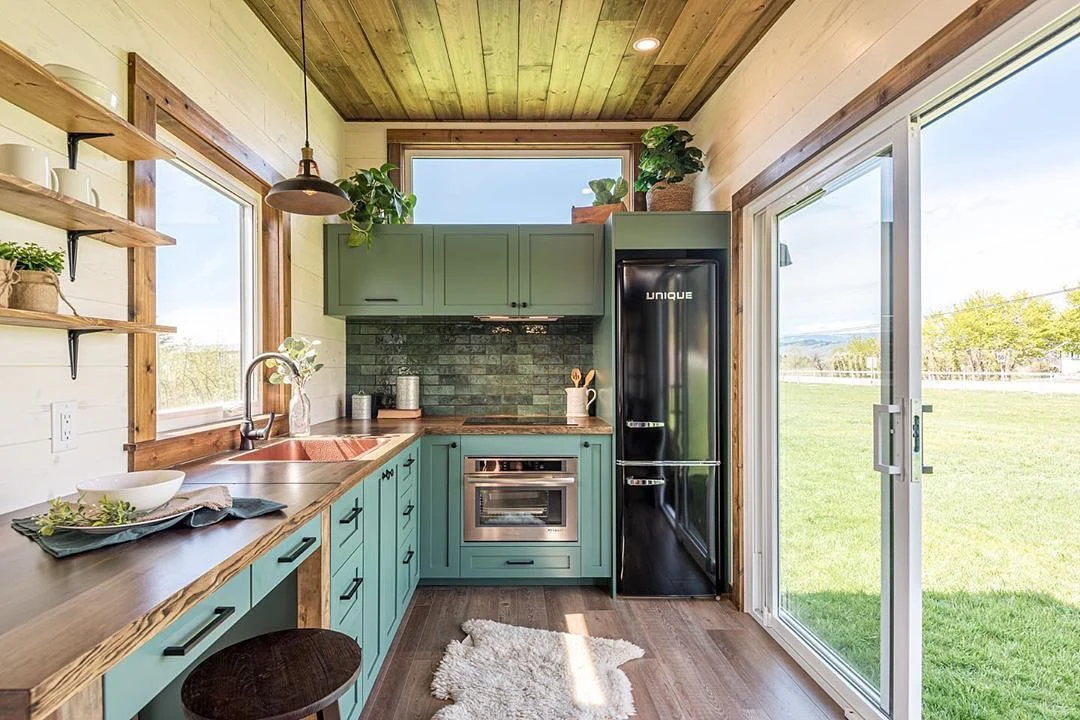 9. Green and Wood Kitchen with Nature Views (Tiny House Kitchen Ideas)