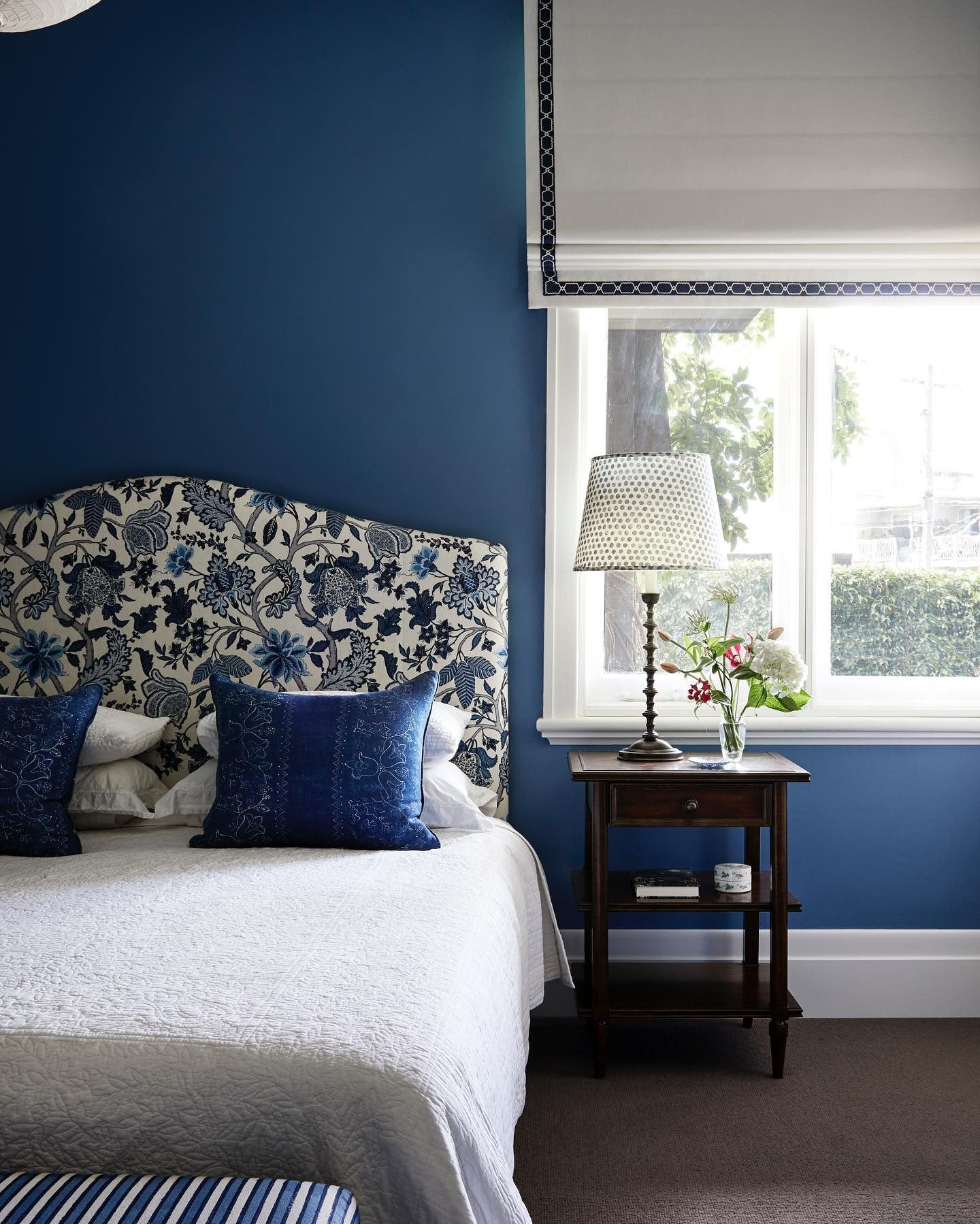7. Deep Blue Walls and Florals (Blue and White Bedroom Ideas)