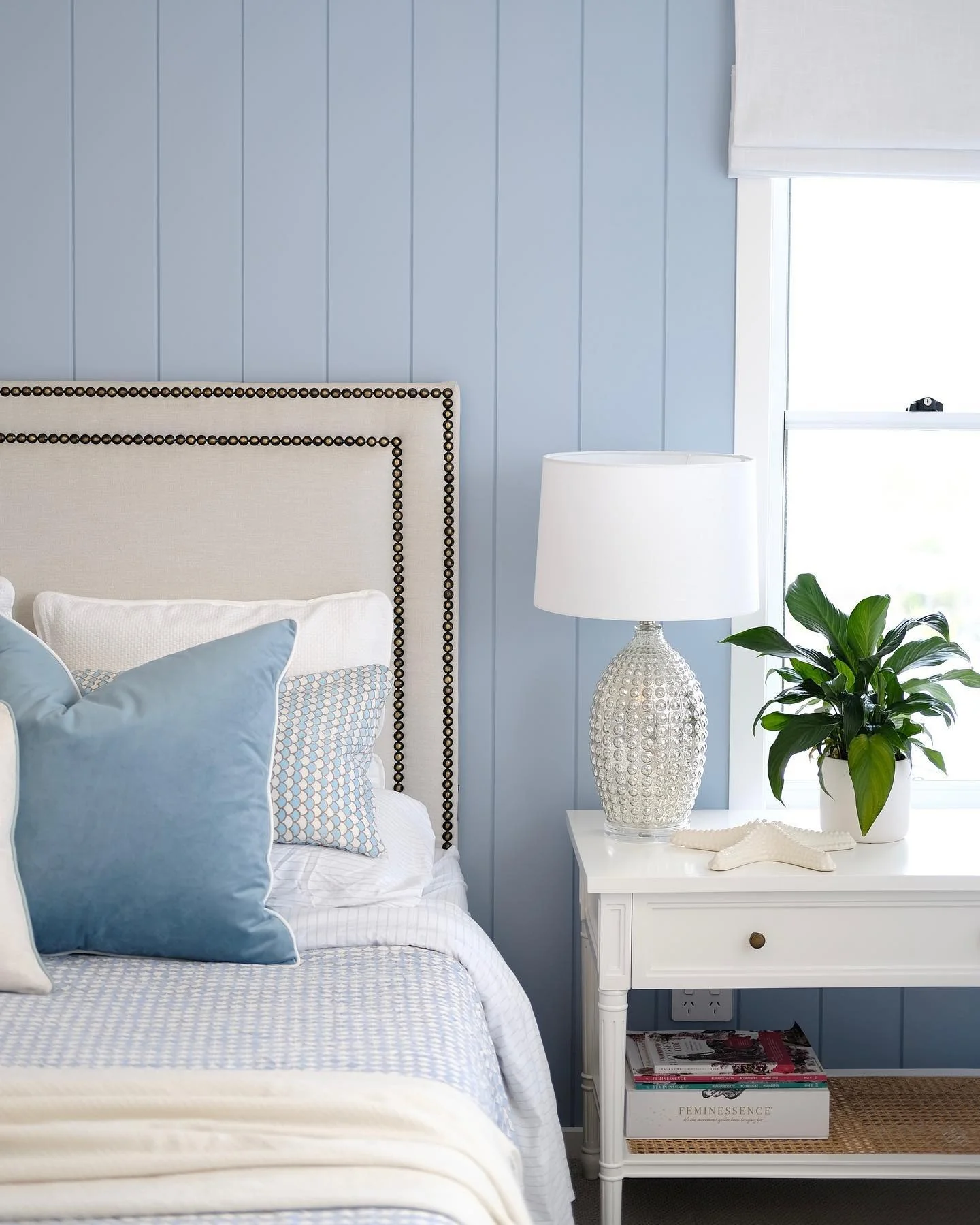8. Pale Blue Paneling with Plush Accents (Blue and White Bedroom Ideas)