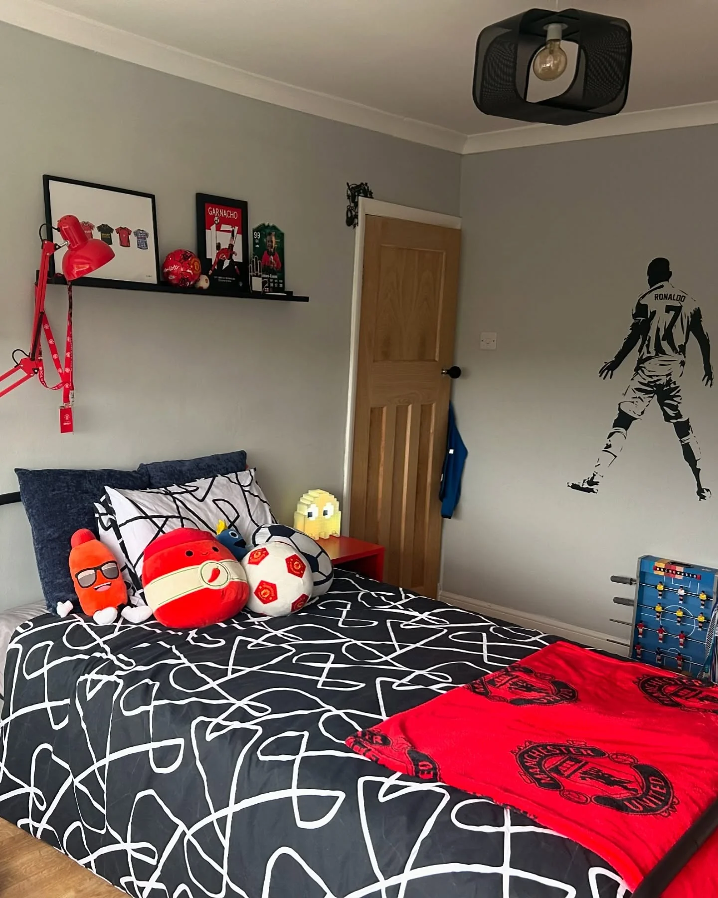 7. Modern Football Accent with Manchester Red (Football Bedroom Ideas)