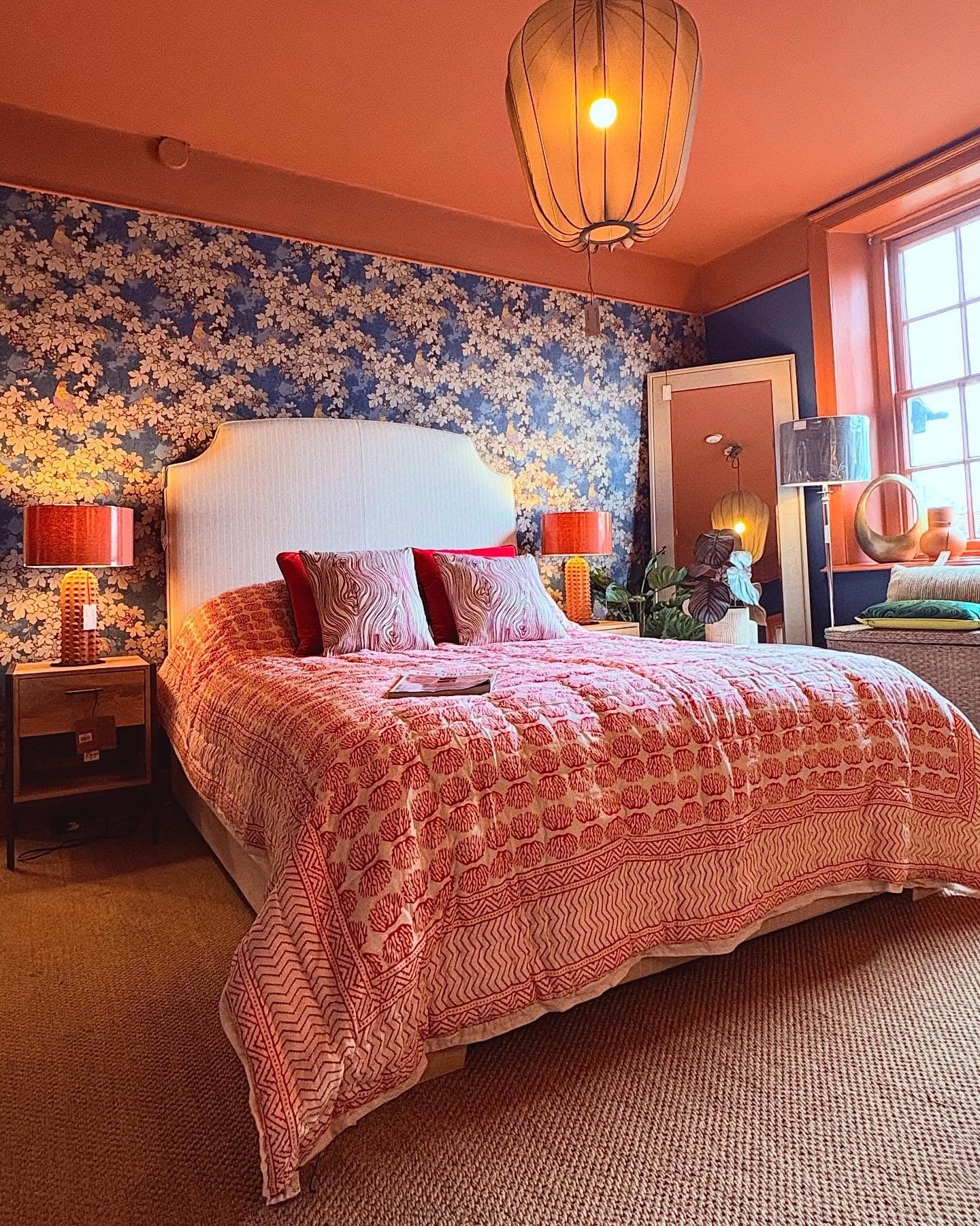 13. Eclectic Coral with Floral Wallpaper and Global Charm (Coral Bedroom Ideas)