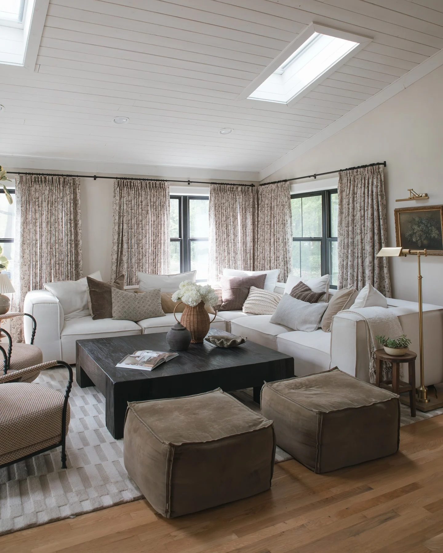 7. Layered Neutral Living with Floral Elegance (Dark Wood Floor Living Room Ideas)