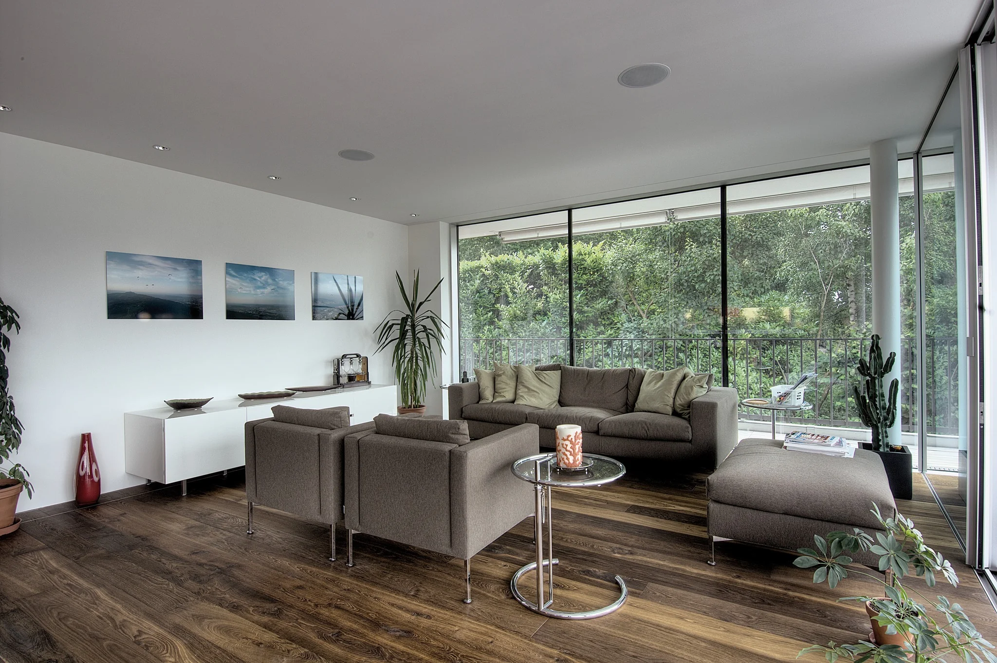 14. Urban Glasshouse with Rich Wood Grain (Dark Wood Floor Living Room Ideas)