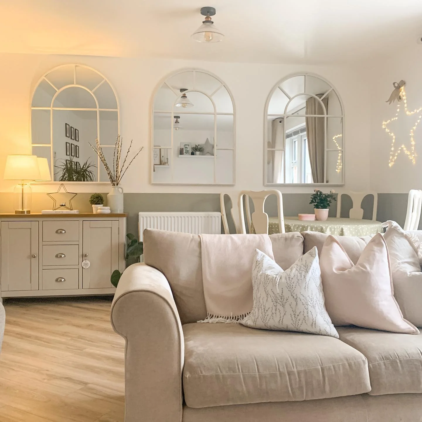 6. Playful Symmetry with Arched Mirrors (Mirrors in Living Room Ideas)