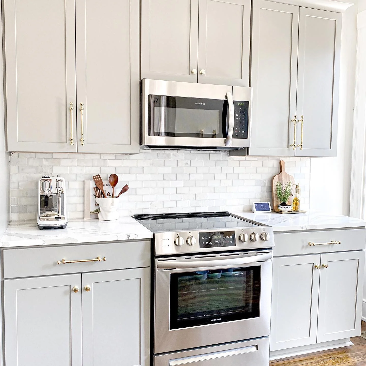 10. Bright Transitional with Brass and Marble Touches (Light Gray Kitchen Ideas)