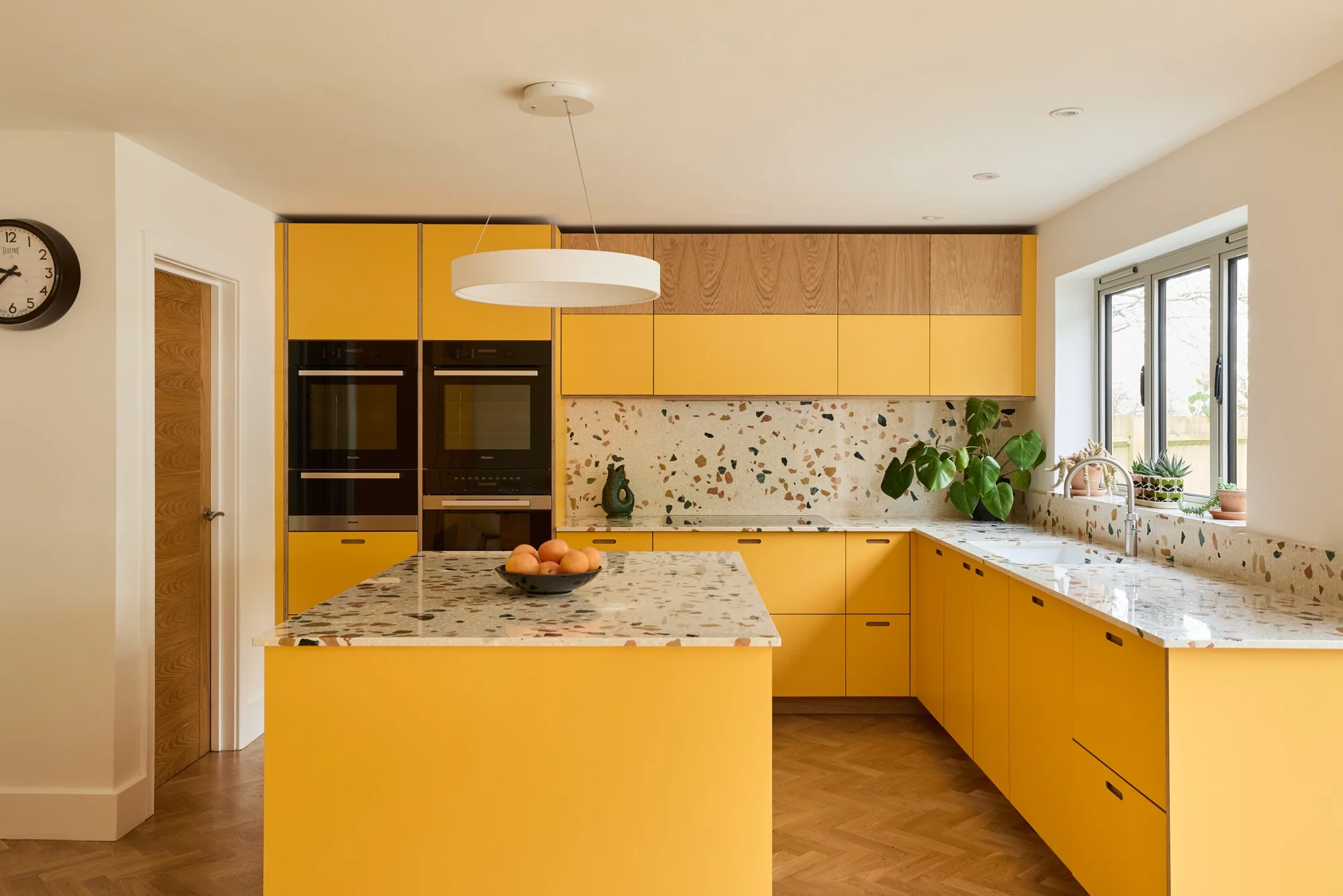 3. Contemporary Terrazzo with Ochre and Neutral Contrast (Yellow Kitchen Ideas)