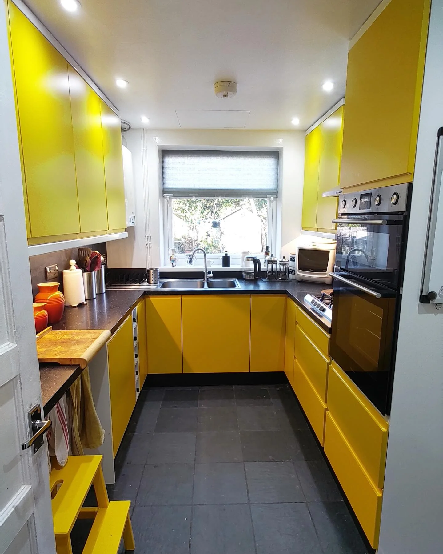 8. Compact Urban Yellow with Black Stone Counters (Yellow Kitchen Ideas)