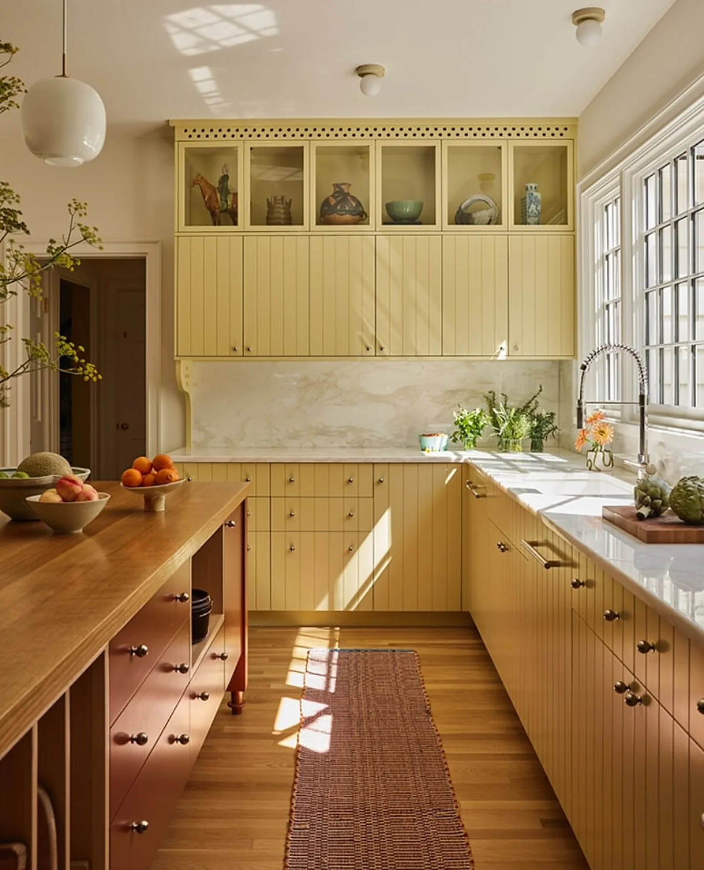15. Buttermilk Paneling with Clay Island and Marble Highlights (Yellow Kitchen Ideas)