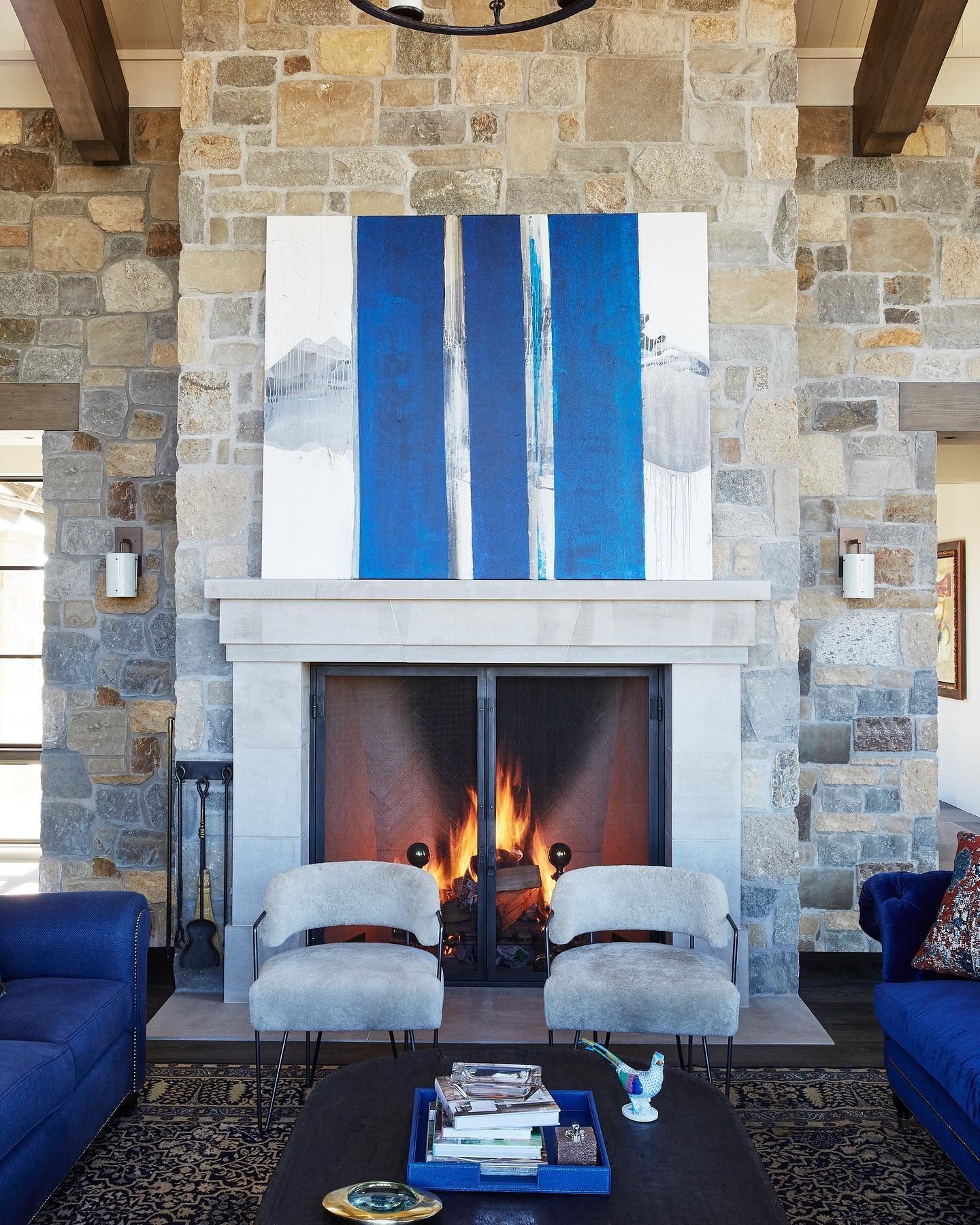 12. Rustic Stone Elegance with a Striking Blue Accent (Royal Blue Living Room Ideas)