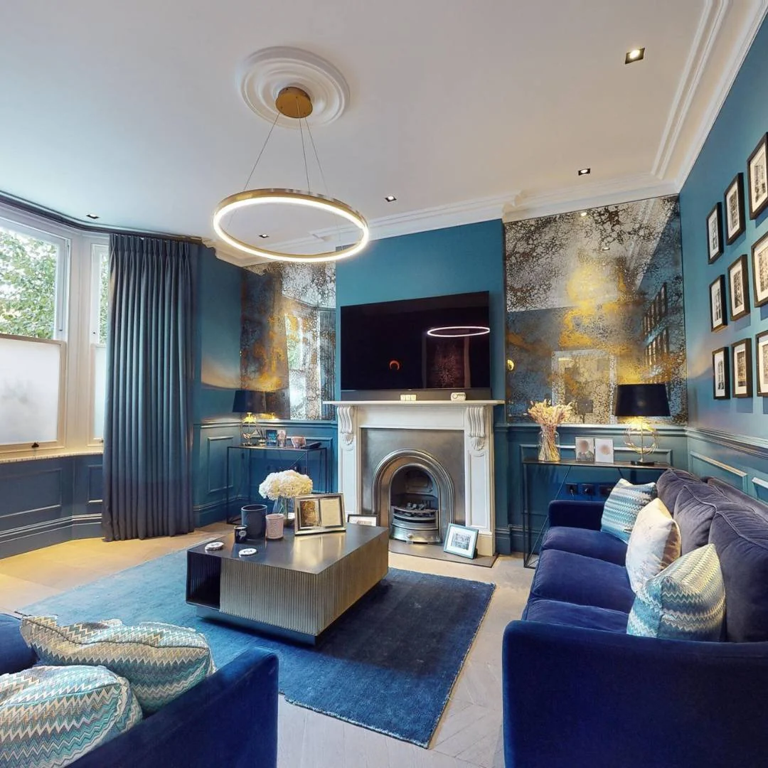 14. Deep-Toned Sophistication Framed by Metallic Murals (Royal Blue Living Room Ideas)