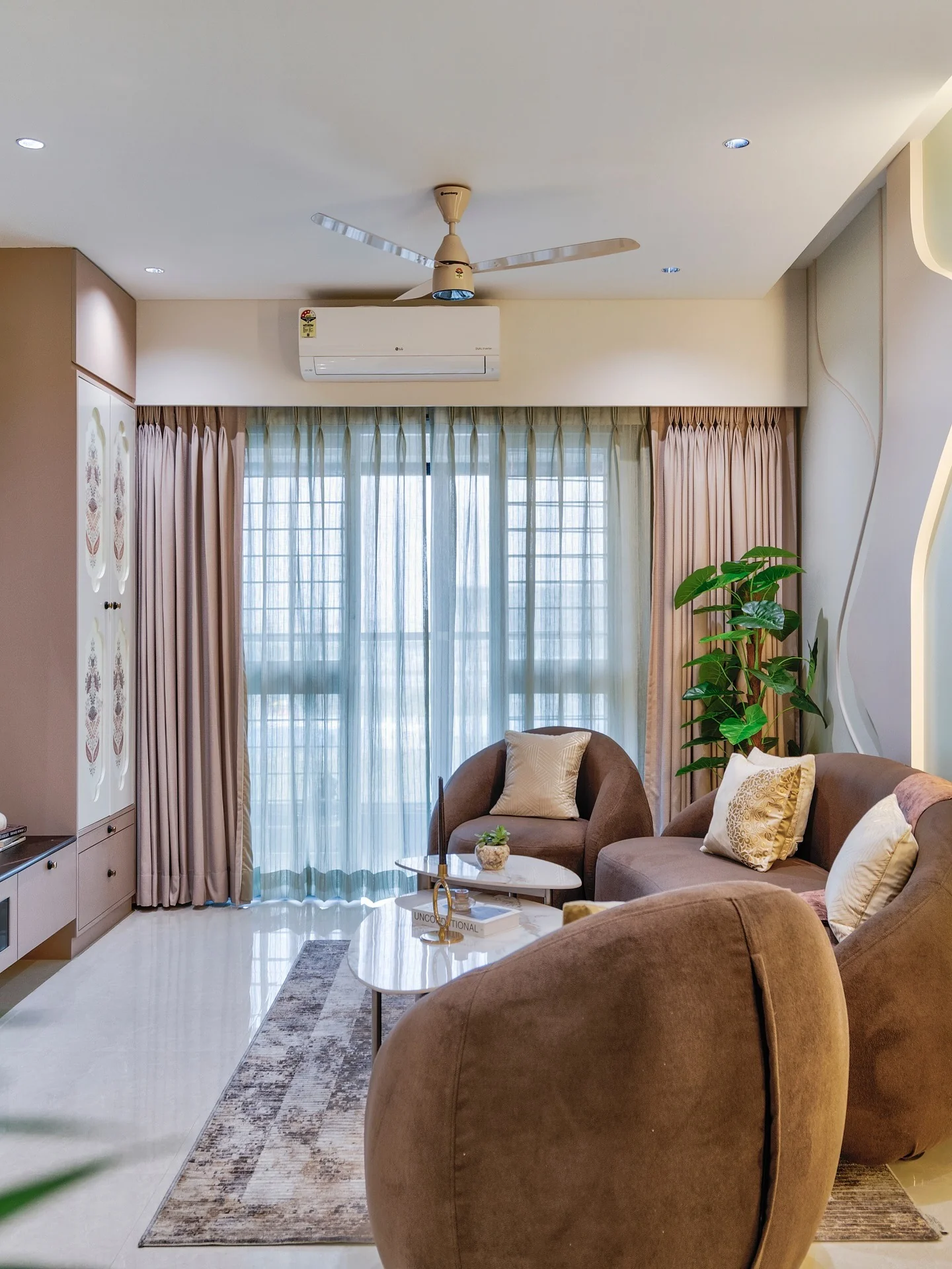 5. Earthy Comfort with Curved Harmony (Dark Brown Living Room Ideas)