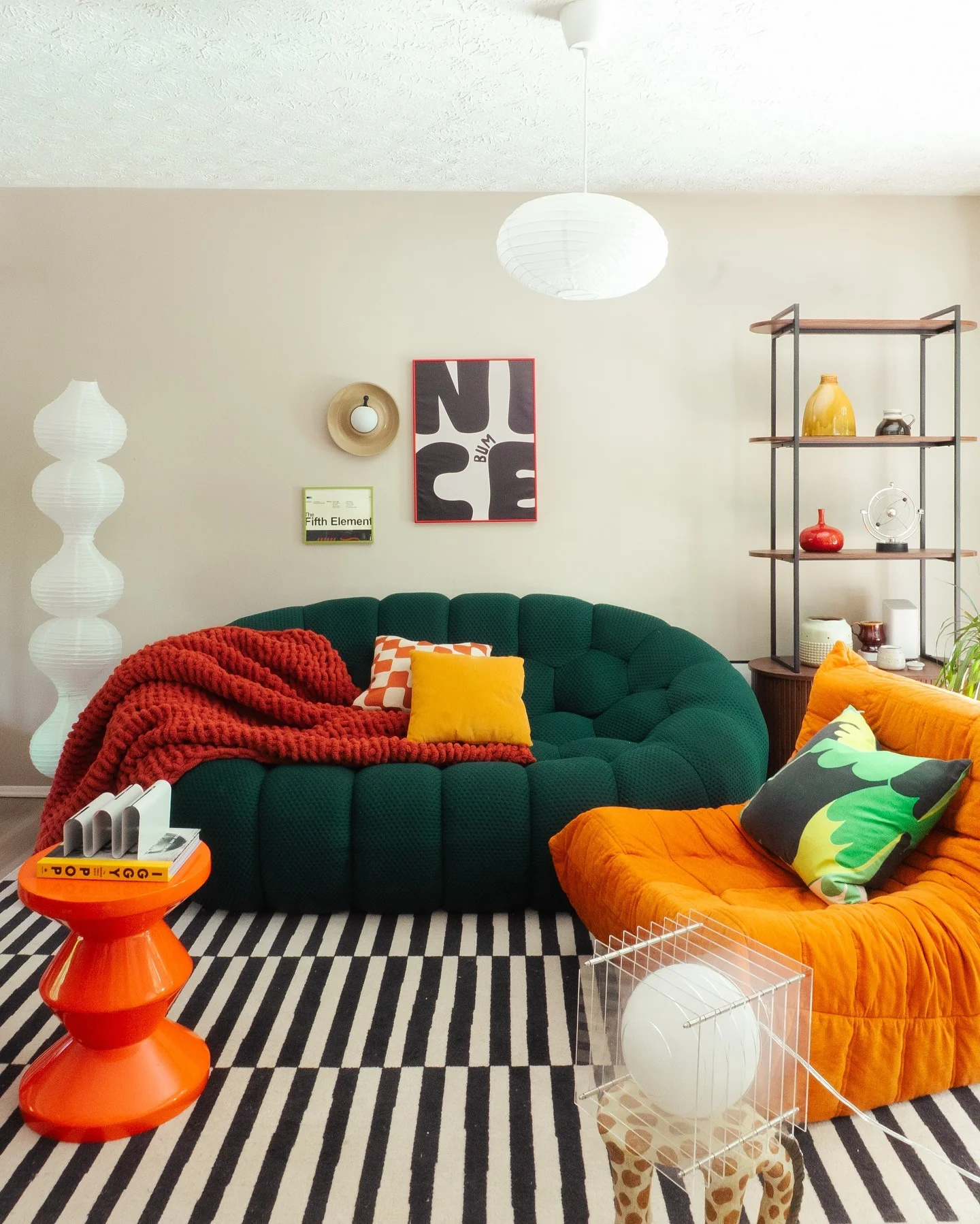 13. Color-Pop Retro Lounge with Deep Green and Orange Seating (Green Couch Living Room Ideas)