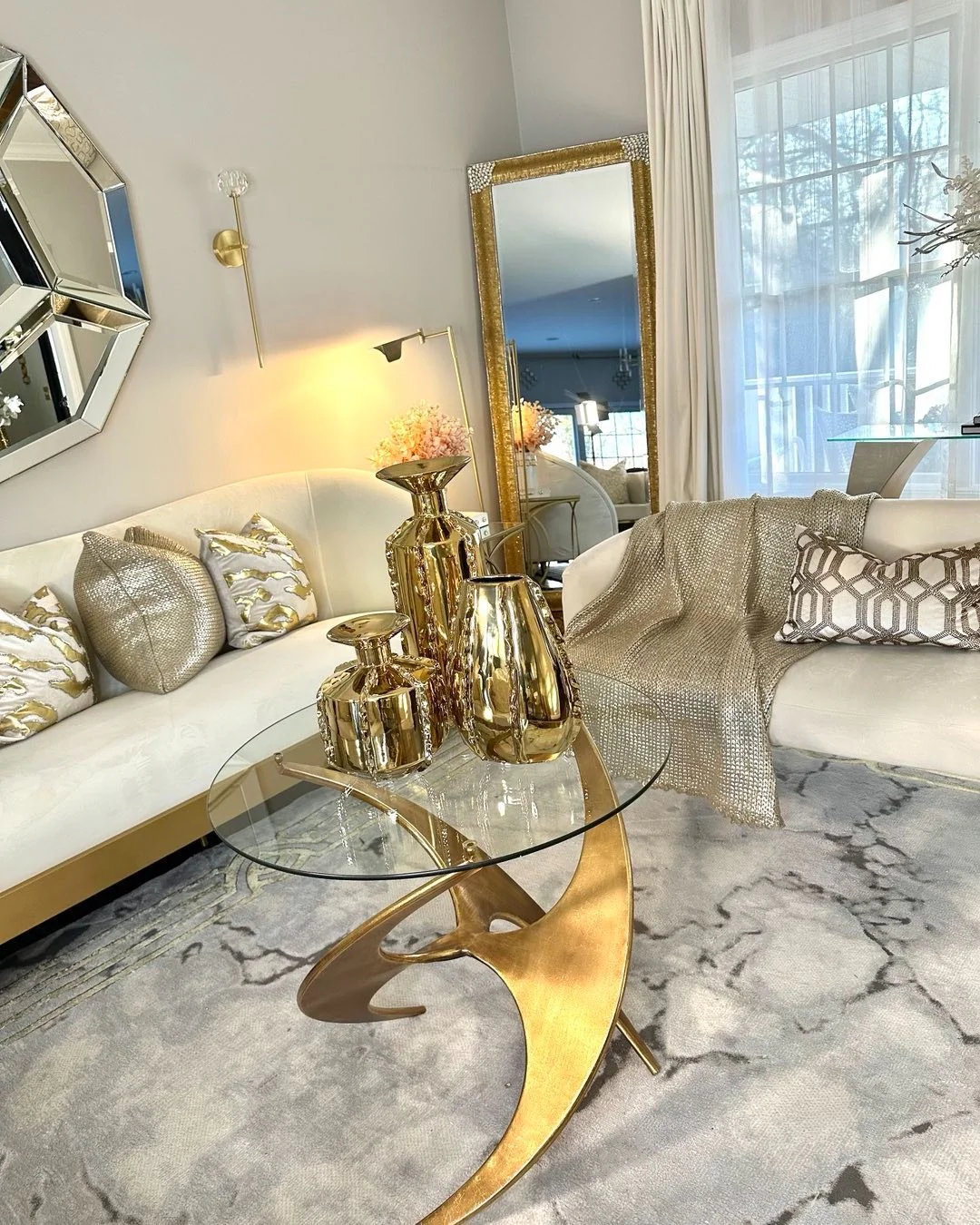 6. Sculptural Chic with Golden Accents (Glam Living Room Ideas)