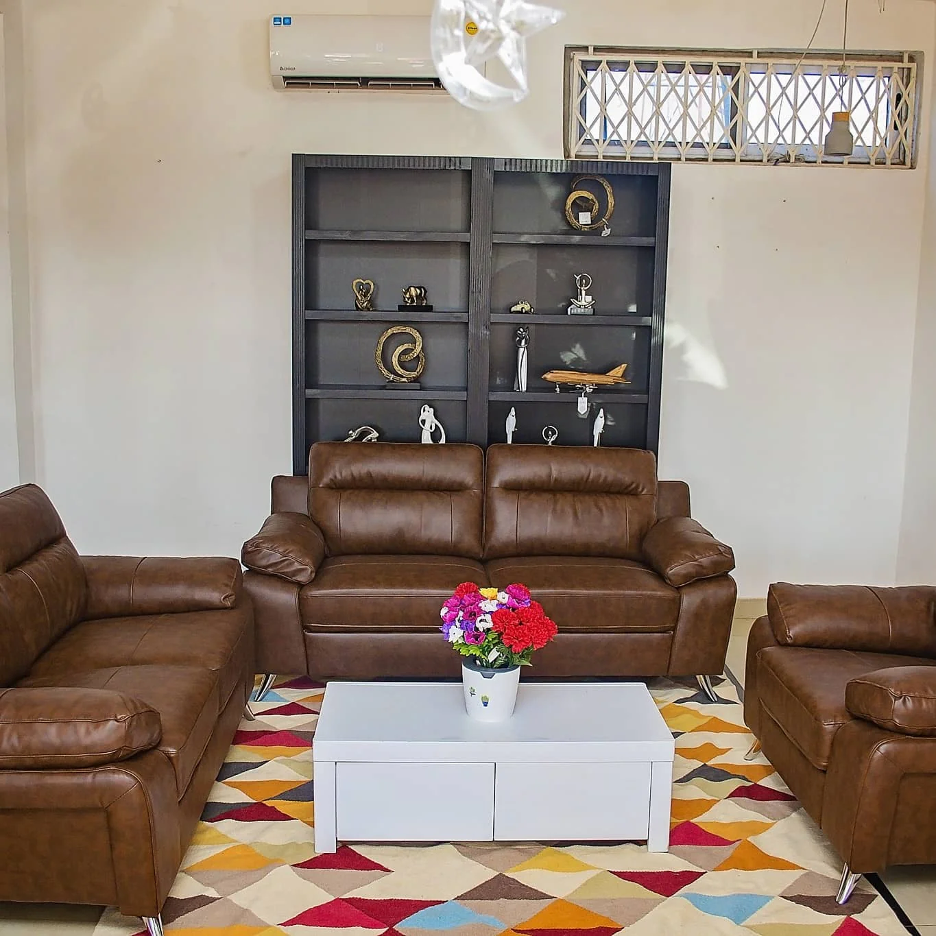 6. Contemporary Classic with a Pop (Brown Leather Sofa Living Room Ideas)