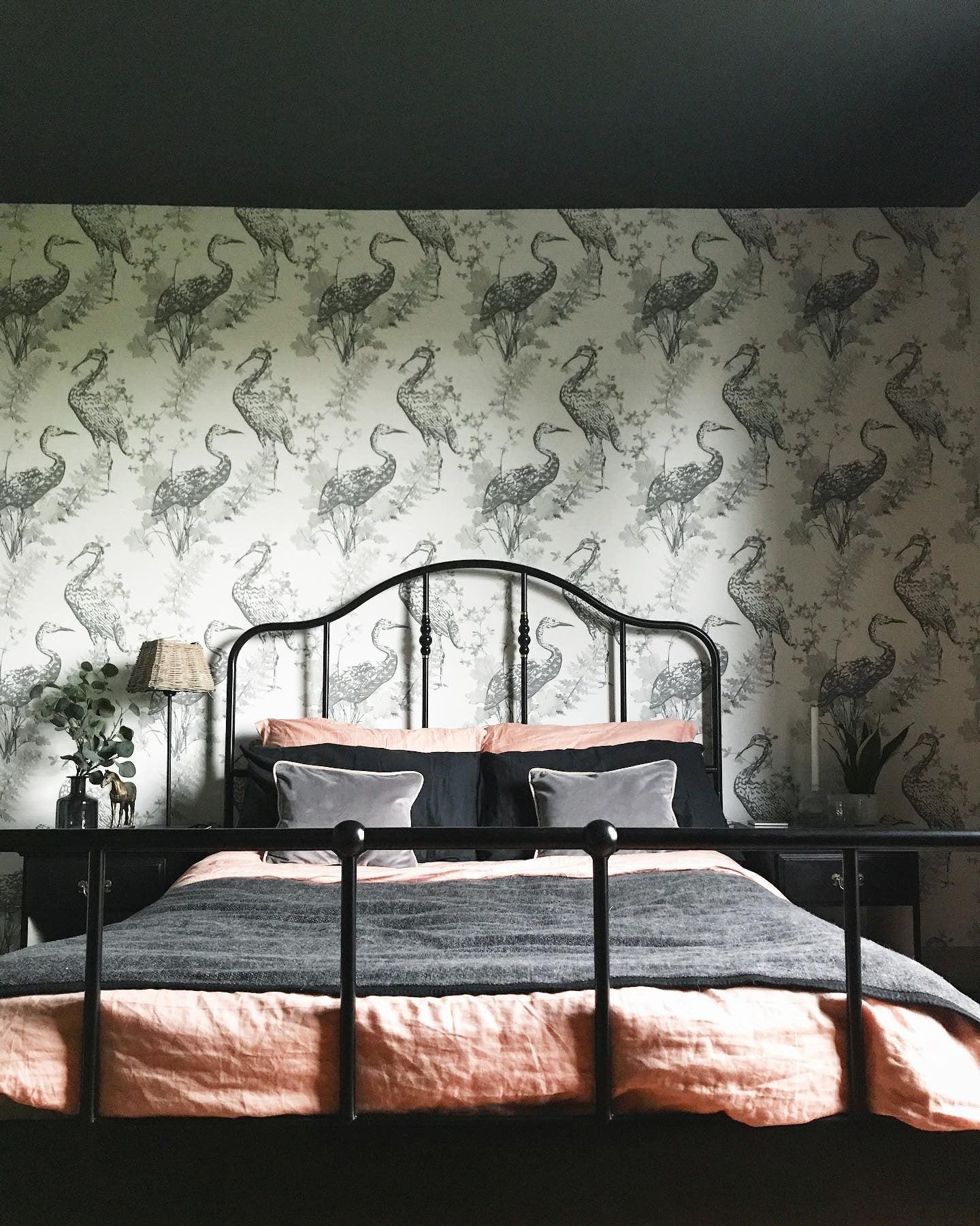 3. Eclectic Elegance with Monochrome Wallpaper Drama (Metal Bed Frame Bedroom Ideas)