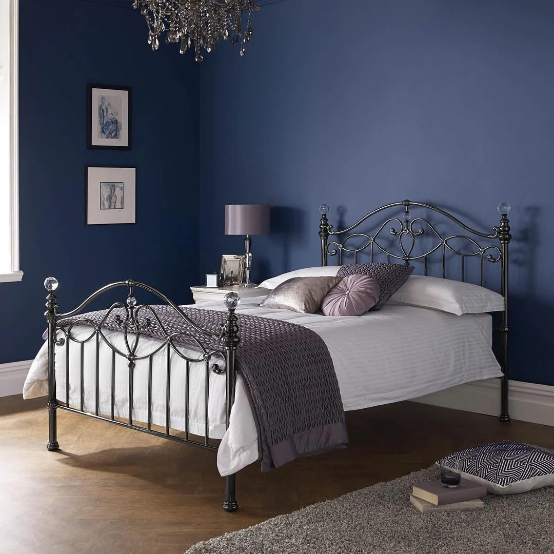 6. Plum Sophistication Against a Deep Blue Wall (Metal Bed Frame Bedroom Ideas)