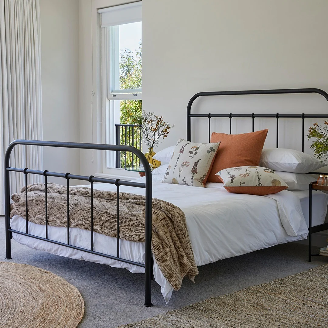 14. Earthy Neutrals with Rust and Floral Accents (Metal Bed Frame Bedroom Ideas)