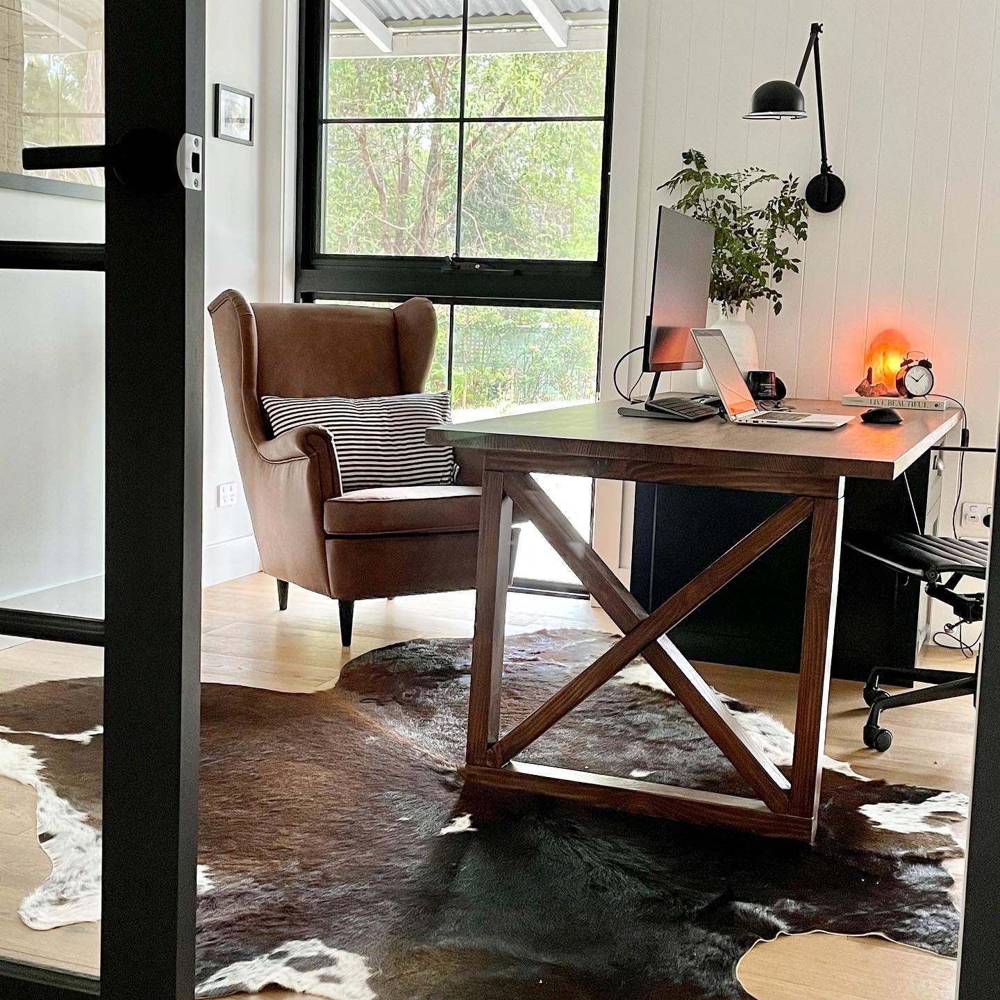 5. Warm Industrial with Cowhide Accent (Farmhouse Office Ideas)